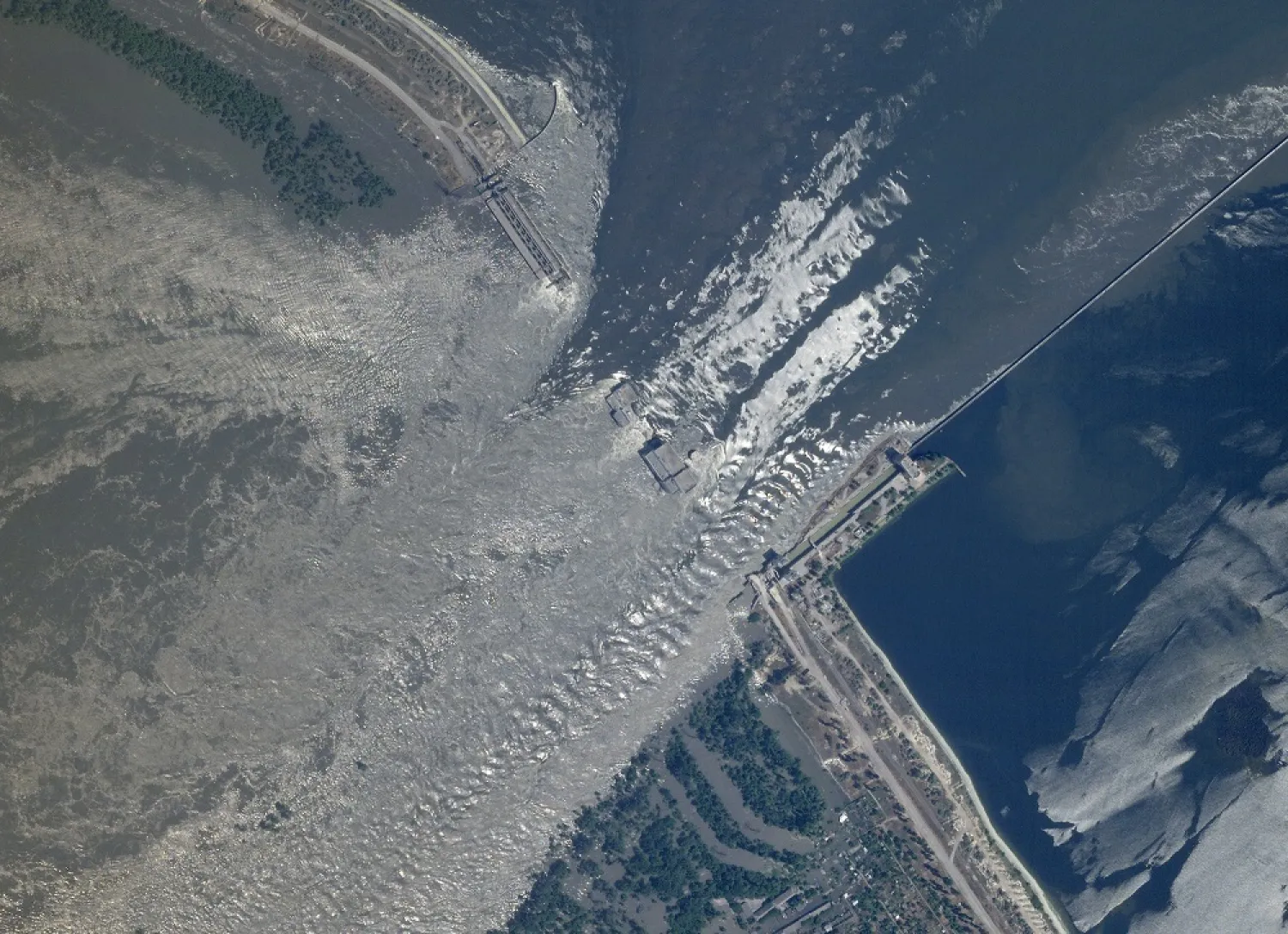 This satellite image provided by Planet Labs PBC shows an overview of the damage on the Kakhovka dam in southern Ukraine on Tuesday, June 6, 2023. (Planet Labs PBC via AP) 