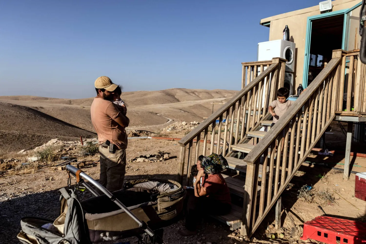 إسرائيليان في منزل متنقل قرب مستوطنة كيدار في الضفة الغربية 27 يونيو الماضي (رويترز)