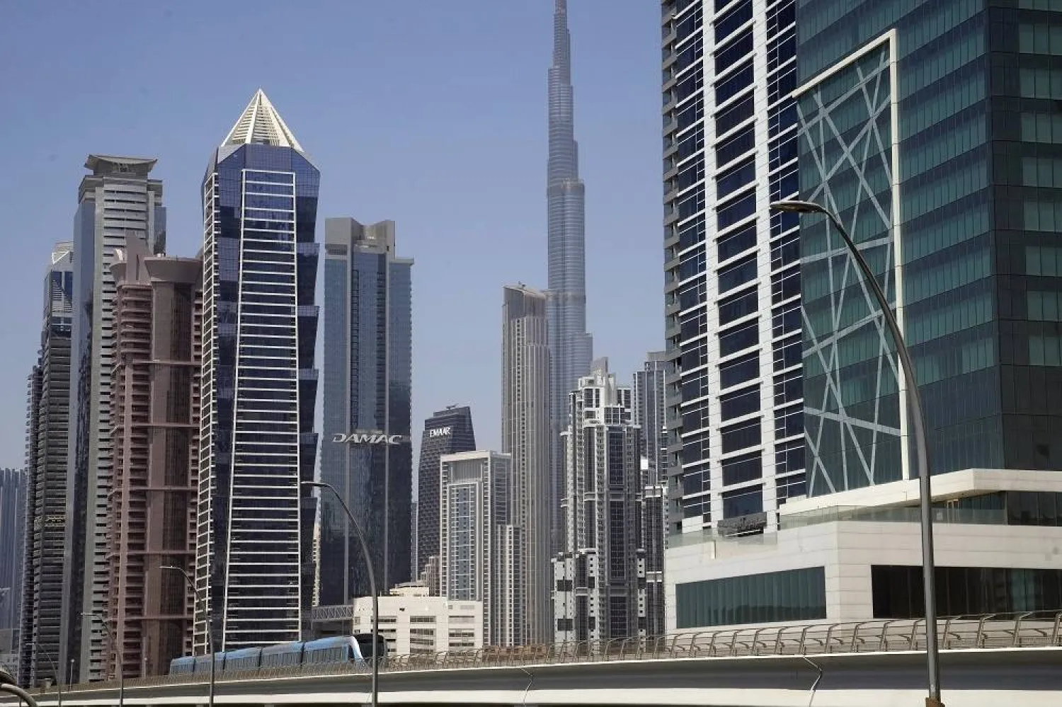 A metro train passes by Burj Khalifa, world's tallest tower, on Sheikh Zayed Highway in Dubai United Arab Emirates, Saturday, July 1, 2023. (AP)