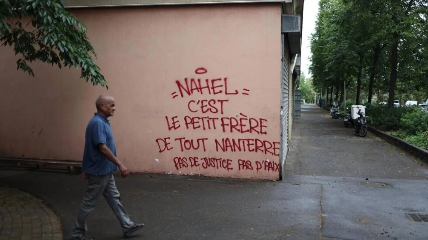 'Nahel is the little brother of all Nanterre, no justice no peace,' reads a message on a wall in the Pablo Picasso neighborhood of Nanterre. CHARLY TRIBALLEAU / AFP/File
