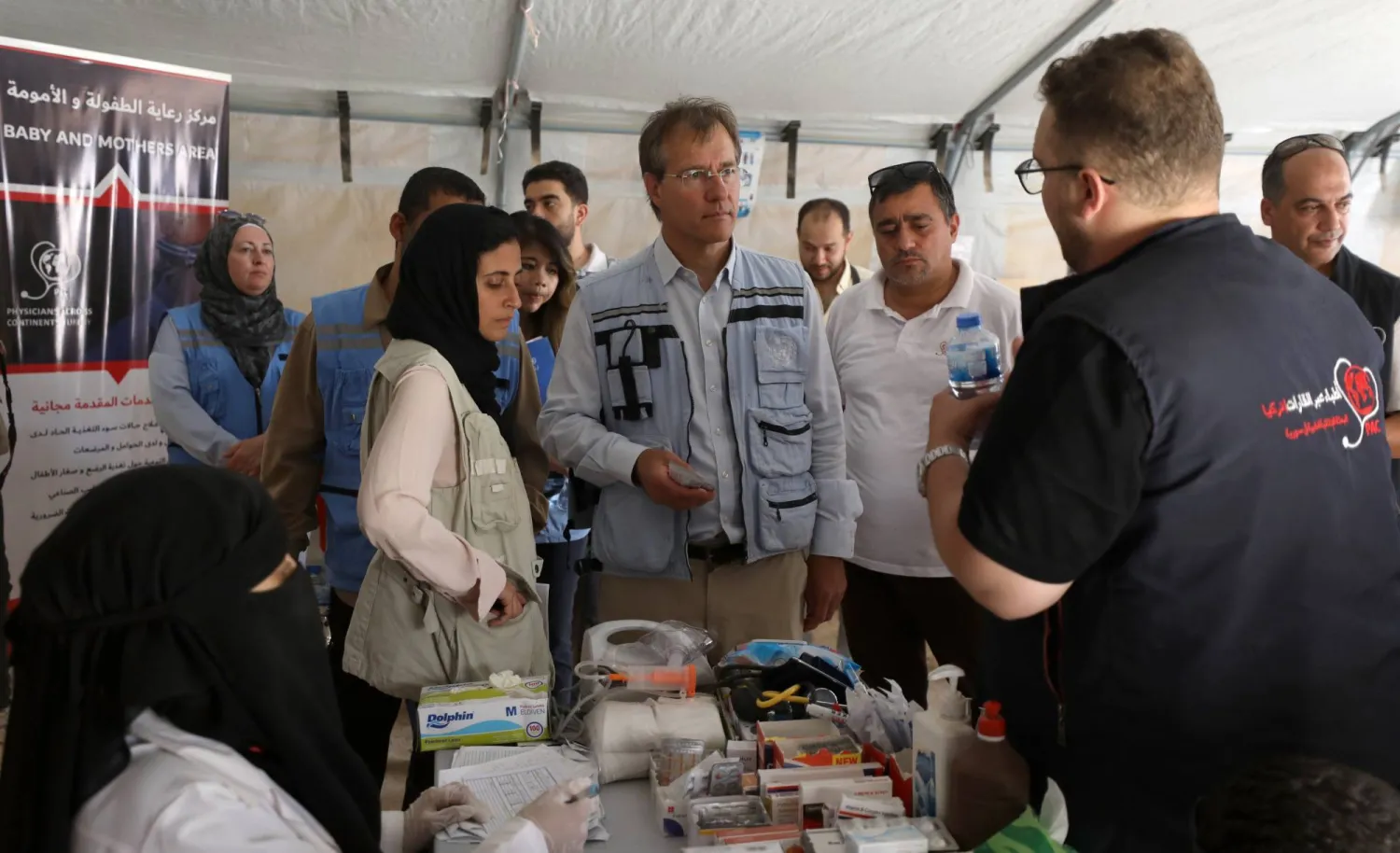 Deputy Regional Humanitarian Coordinator for the Syria Crisis David Carden (2-L) listens to an unidentified official during a visit at a maternity and child care area during a tour in Idlib Governorate, Syria, 04 July 2023. (EPA)