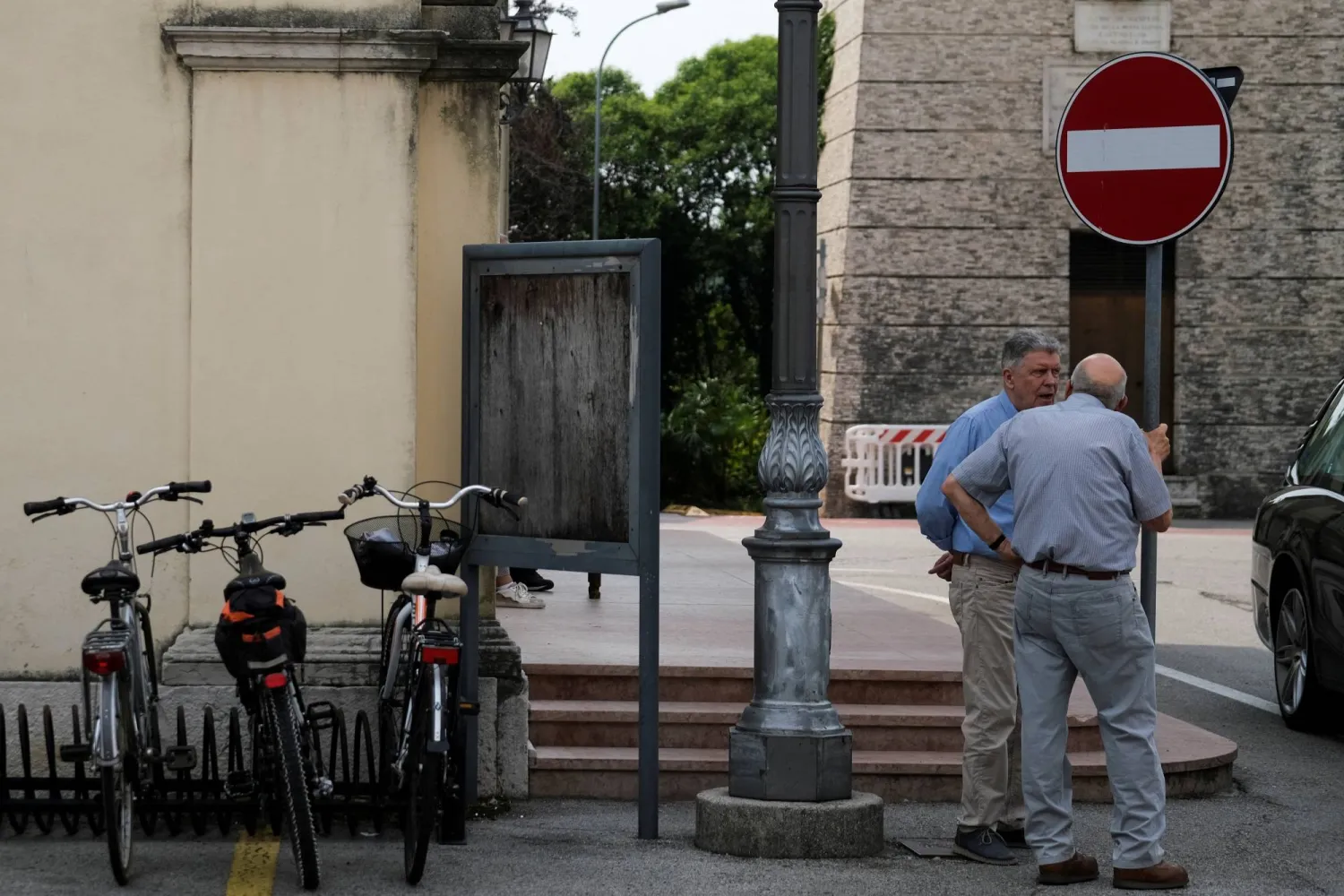 Two elderly men speak in the square of Cartigliano, a small town in northern Italy, where firms are offering money to families to help them enroll children in nursery schools, Italy May 27, 2022. Picture taken May 27, 2022 REUTERS/Manuel Silvestri/File Photo

