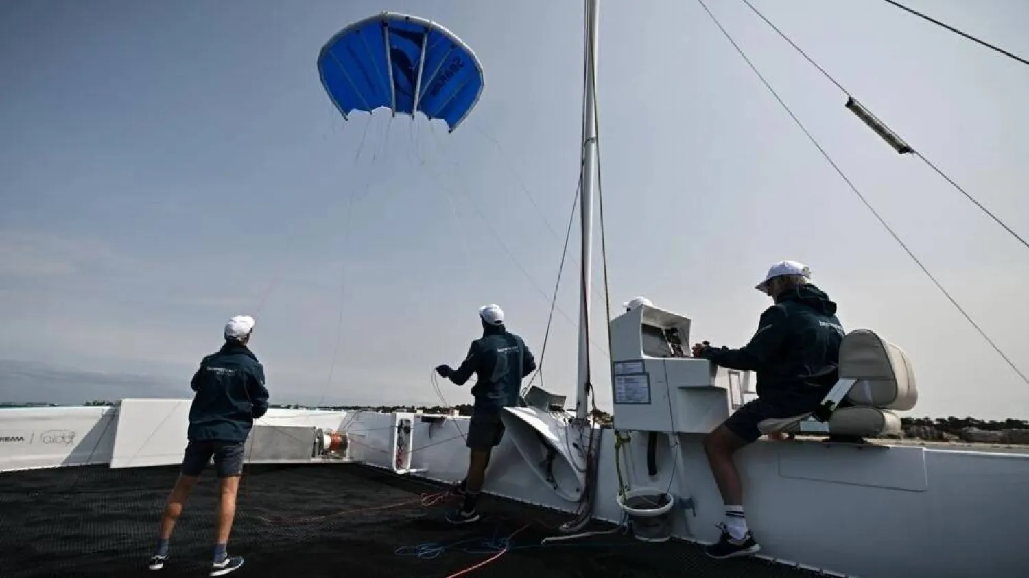 The startup Beyond The Sea tests a blue inflatable kite sail the size of a small studio to pull a specially-designed catamaran across the water. Philippe LOPEZ / AFP/File
