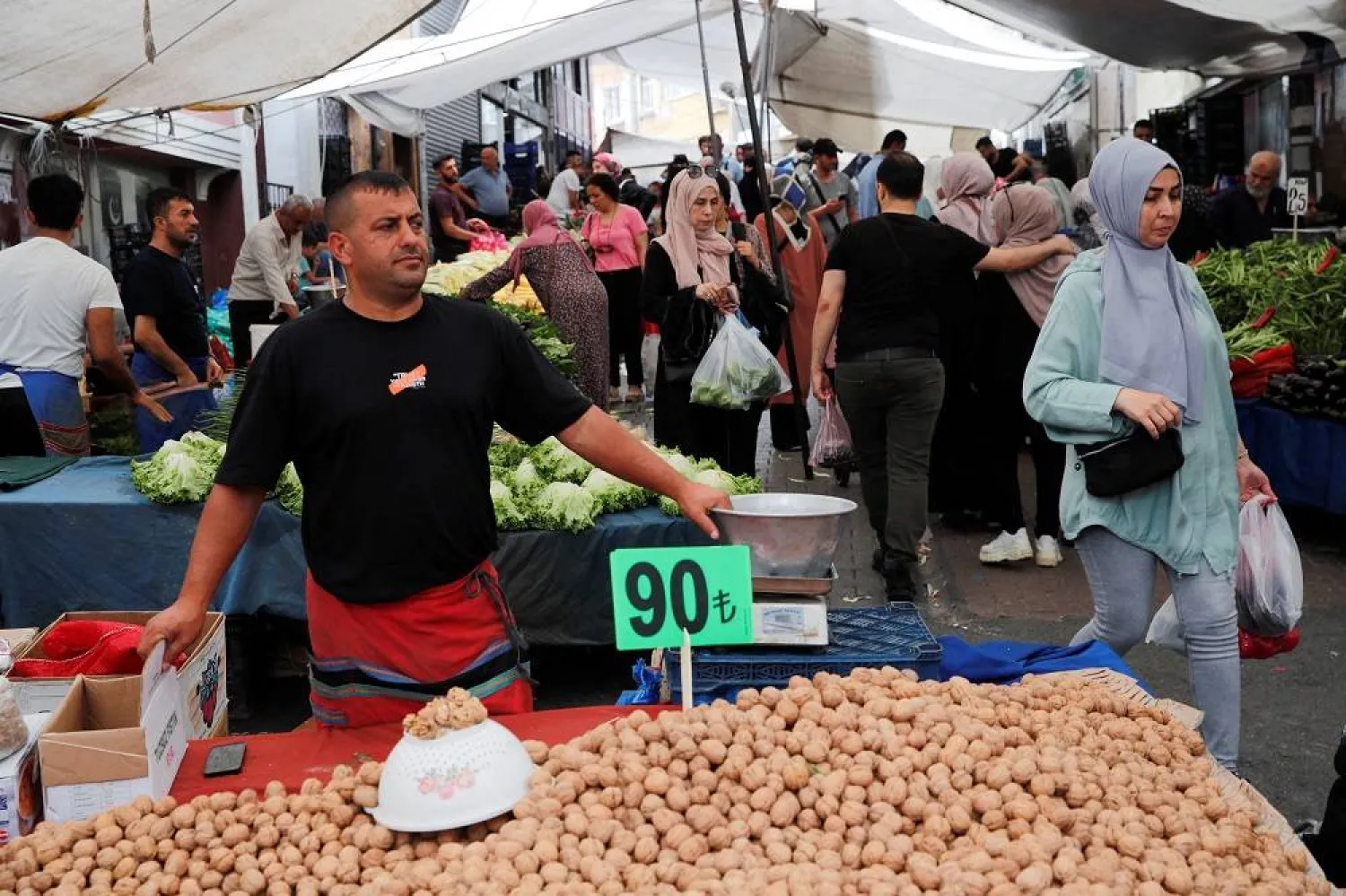 Mirza Ozbag, 44, a vendor, waits for customers at his stall at a fresh market in Istanbul, Türkiye July 5, 2023. (Reuters)