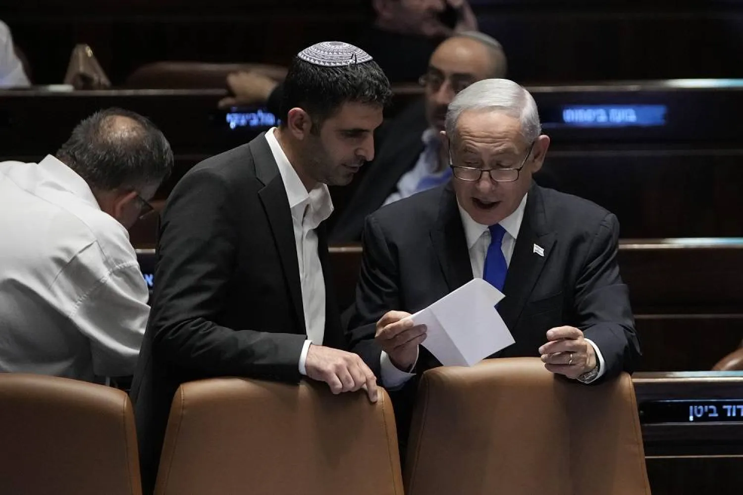 Israel's Prime Minister Benjamin Netanyahu, right, speaks to Minister of Communications Shlomo Karhi at the Knesset, Israel's parliament, in Jerusalem, Monday, July 10, 2023. (AP)