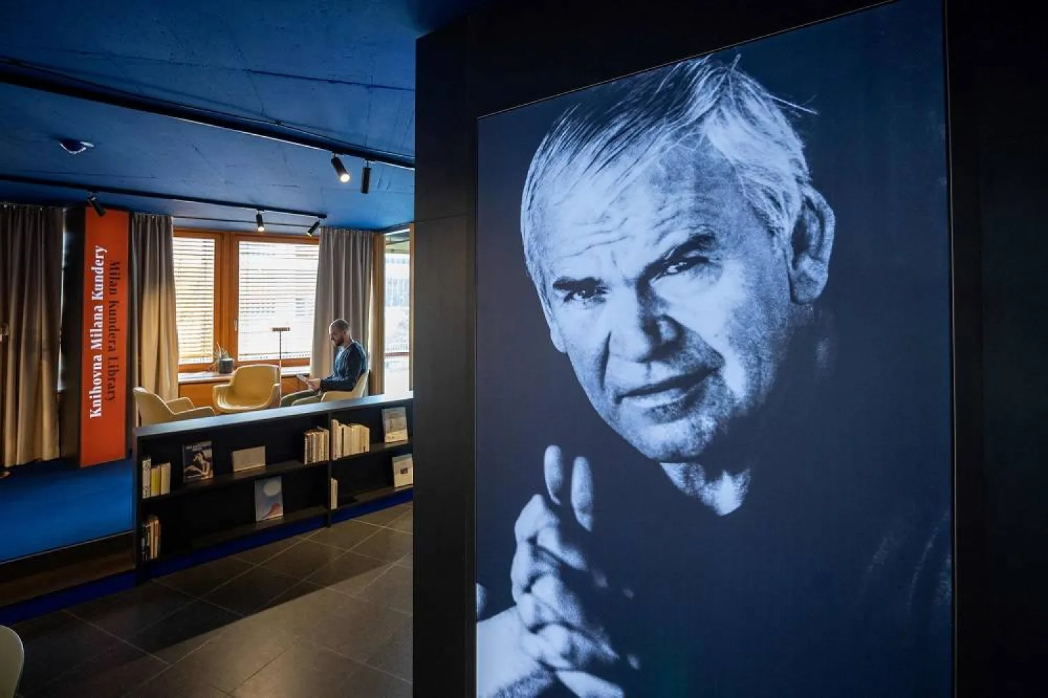 A visitor to the Milan Kundera library in Brno, Czech Republic reads a book by the Czech novelist on April 6, 2023. (AFP)