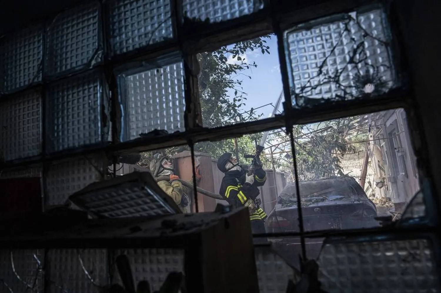 Ukrainian State Emergency Service firefighters put out a fire at a house destroyed in a Russian shelling, in a residential neighborhood in Kherson, Ukraine, Saturday, July 1, 2023. (AP) 