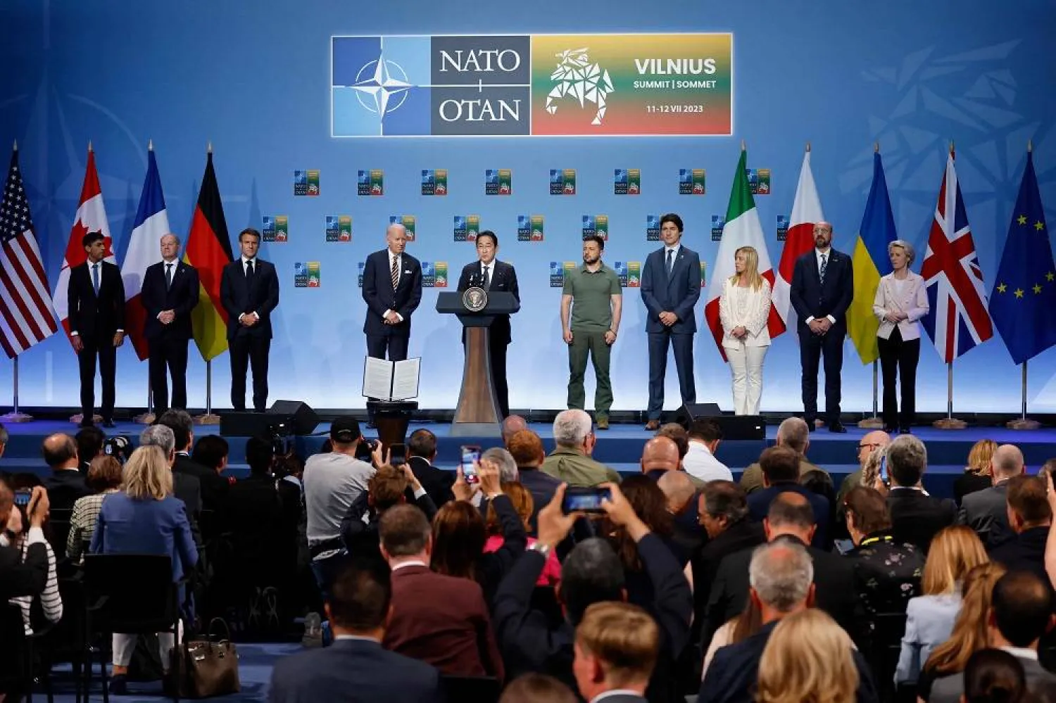 (L to R) Britain's Prime Minister Rishi Sunak, Germany's Chancellor Olaf Scholz, France's President Emmanuel Macron, US President Joe Biden, Japan's Prime Minster Fumio Kishida, Ukraine's President Volodymyr Zelenskiy, Canada's Prime Minister Justin Trudeau, Italy's Prime Minister Giorgia Meloni, European Council President Charles Michel and President of the European Commission Ursula von der Leyen attend an event to announce a Joint Declaration of Support for Ukraine during the NATO summit, in Vilnius on July 12, 2023. (AFP) 