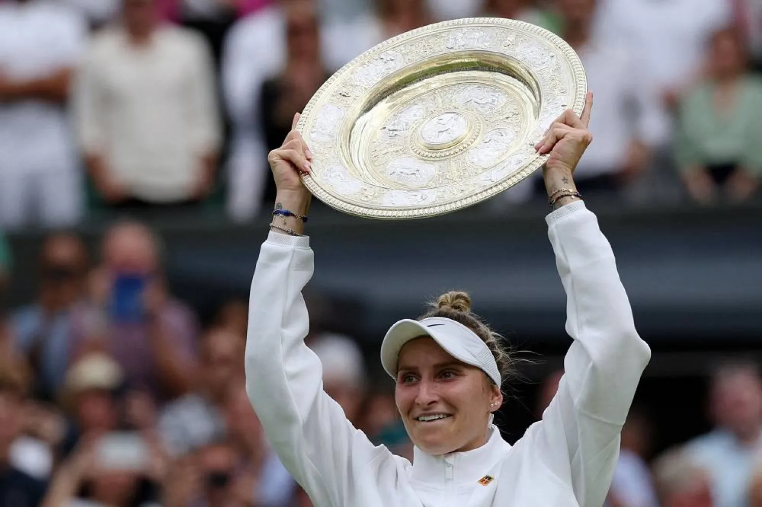Czech Republic's Marketa Vondrousova celebrates with the Venus Rosewater Dish trophy during the prize ceremony after winning the women's singles final tennis match against Tunisia's Ons Jabeur on the thirteenth day of the 2023 Wimbledon Championships at The All England Lawn Tennis Club in Wimbledon, southwest London, on July 15, 2023. (AFP) 