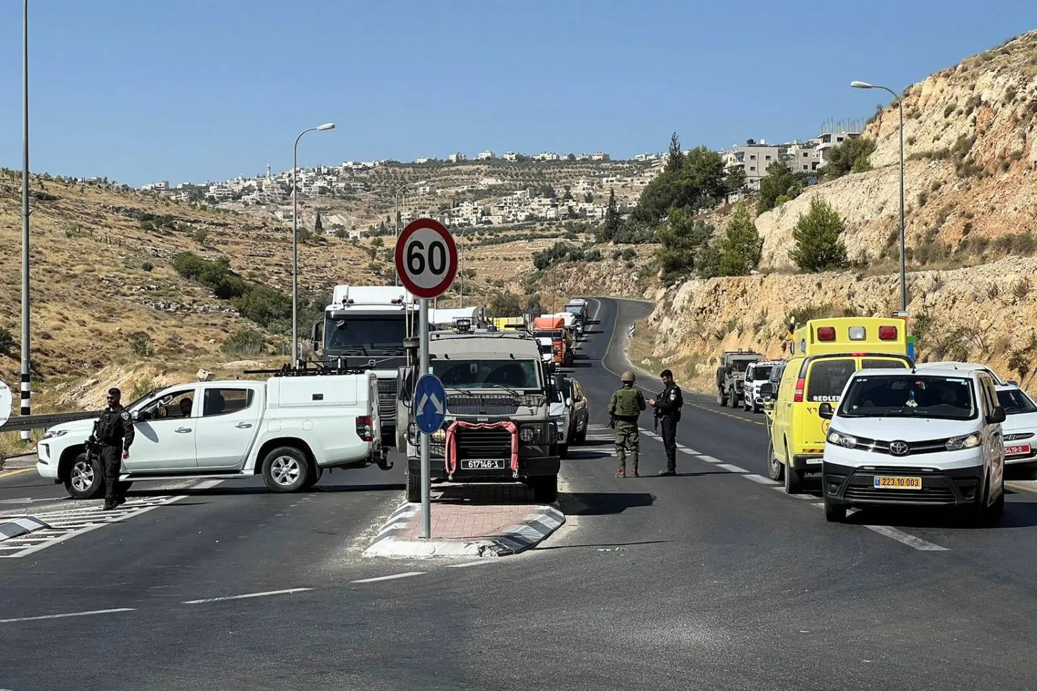 Israeli military and security personnel work at the scene of a shooting attack at Tekoa Junction in the Israeli-occupied West Bank, July 16, 2023. REUTERS/Dedi Hayun