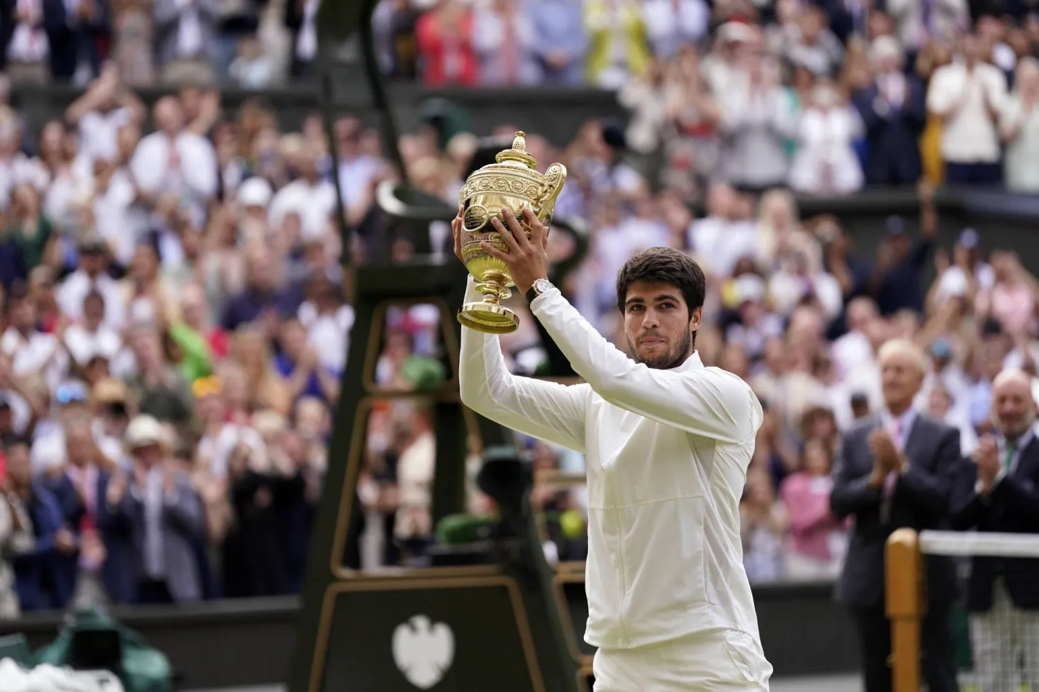 Spain's Carlos Alcaraz celebrates with his trophy after beating Serbia's Novak Djokovic in the men's singles final on day fourteen of the Wimbledon tennis championships in London, Sunday, July 16, 2023. (AP Photo/Alberto Pezzali)