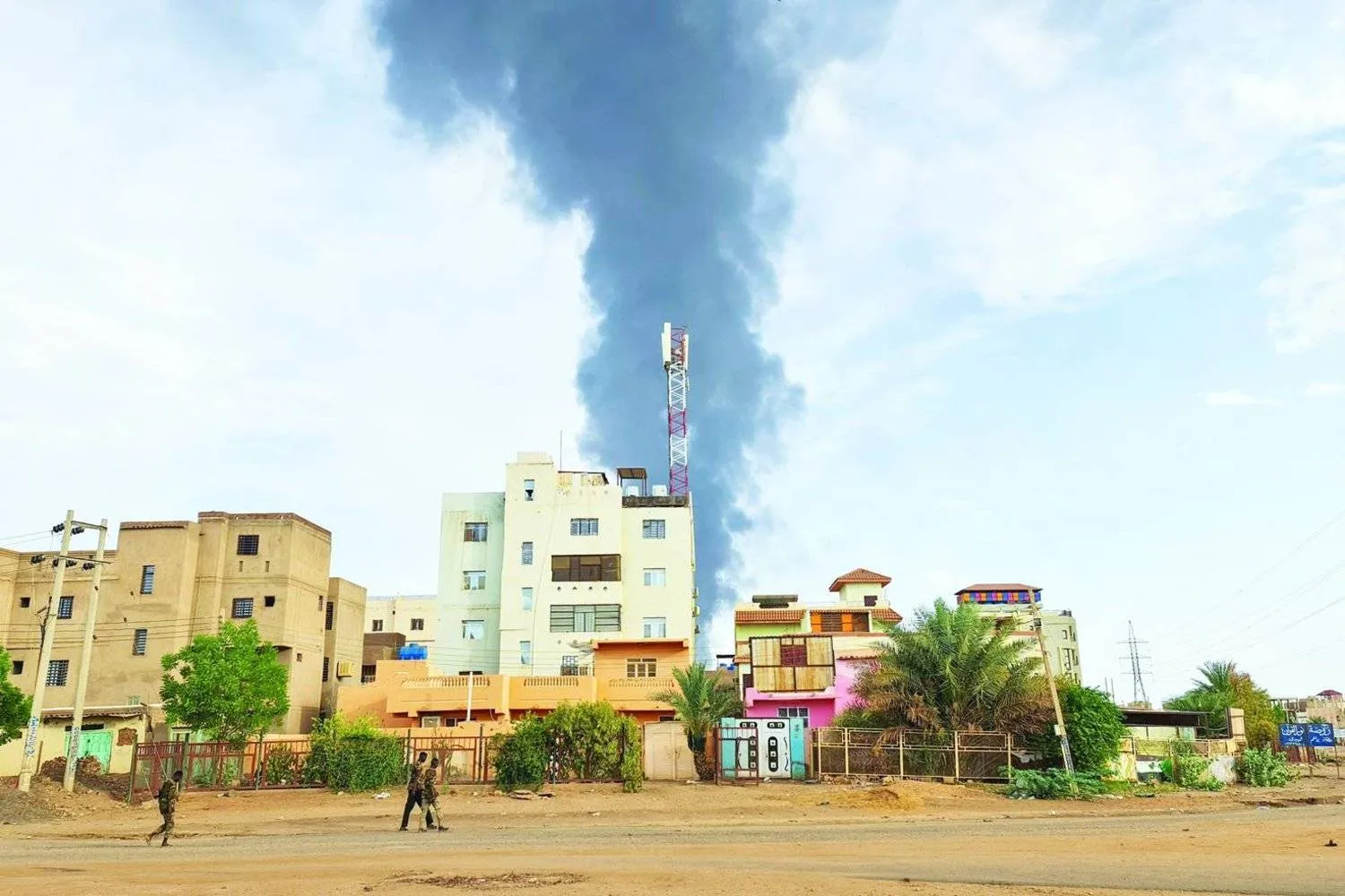 Black smoke billows behind buildings amid ongoing fighting in Khartoum on June 9, 2023. (Photo by AFP)
