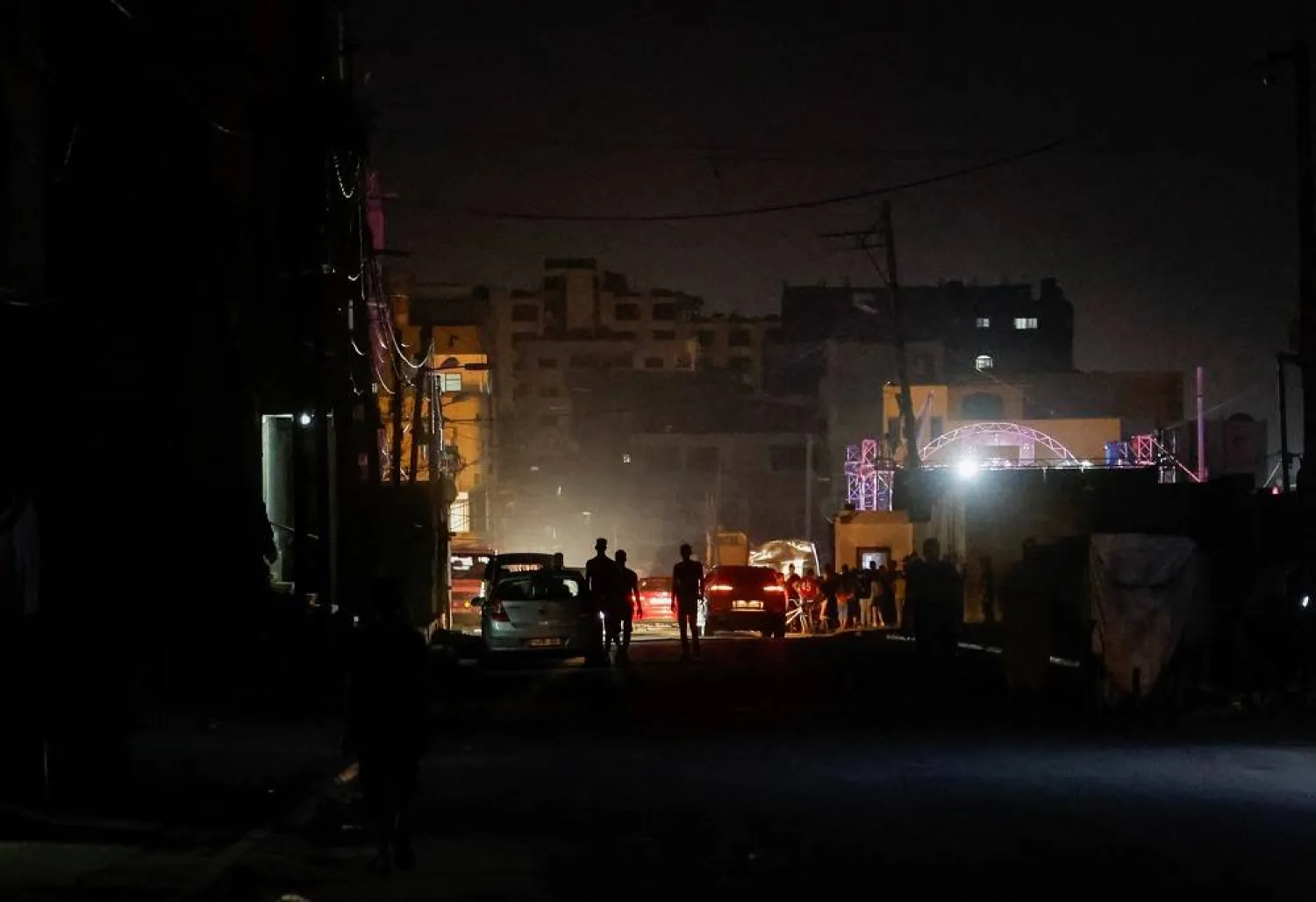 Palestinians walk in the street amid a heatwave and lengthy power cuts at Shati refugee camp in Gaza City, July 17, 2023. (Reuters)