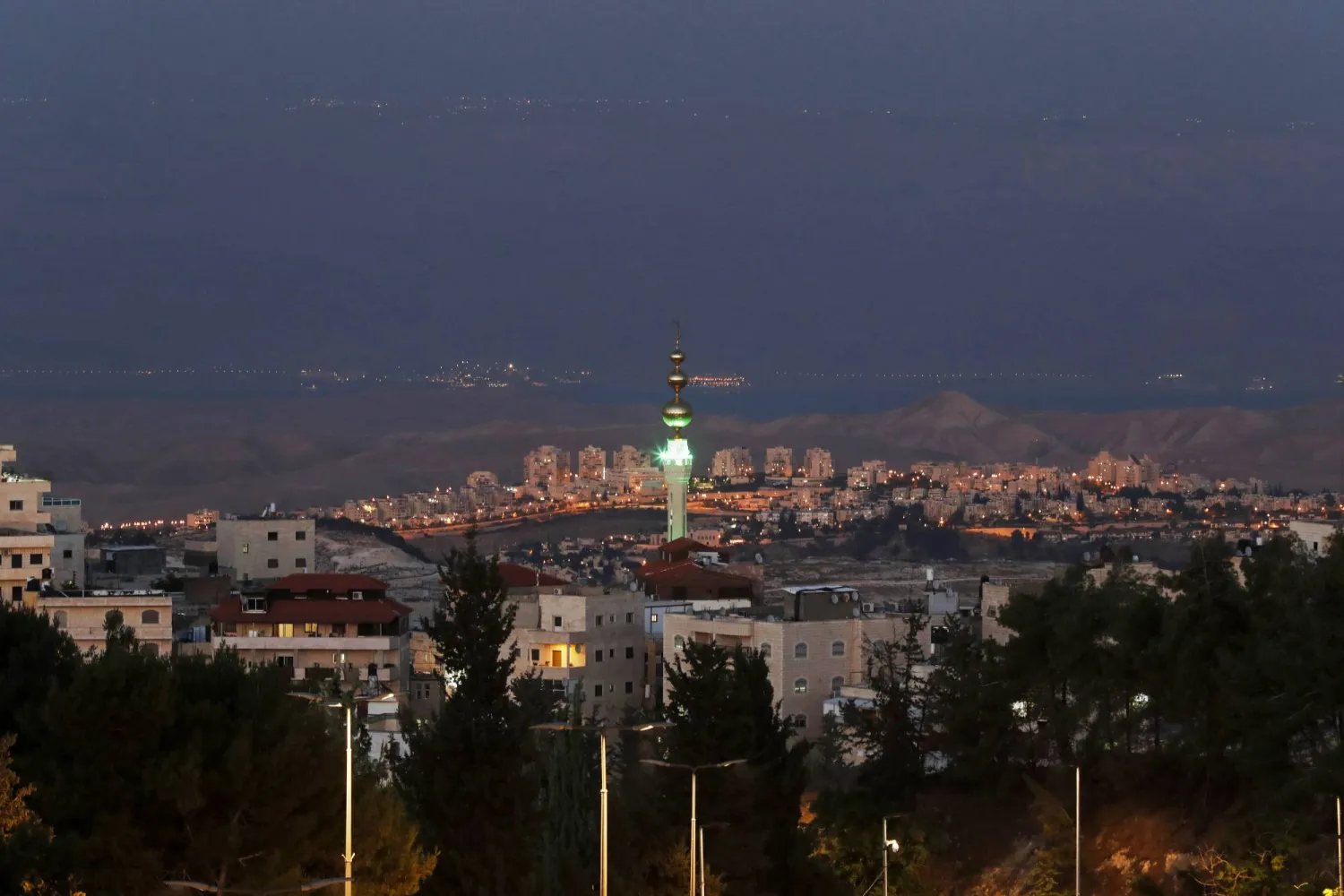 حي العيسوية بالقدس الشرقية ومستوطنة معاليه أدوميم في الوسط والبحر الميت والأردن في الخلفية (إ.ب.أ)