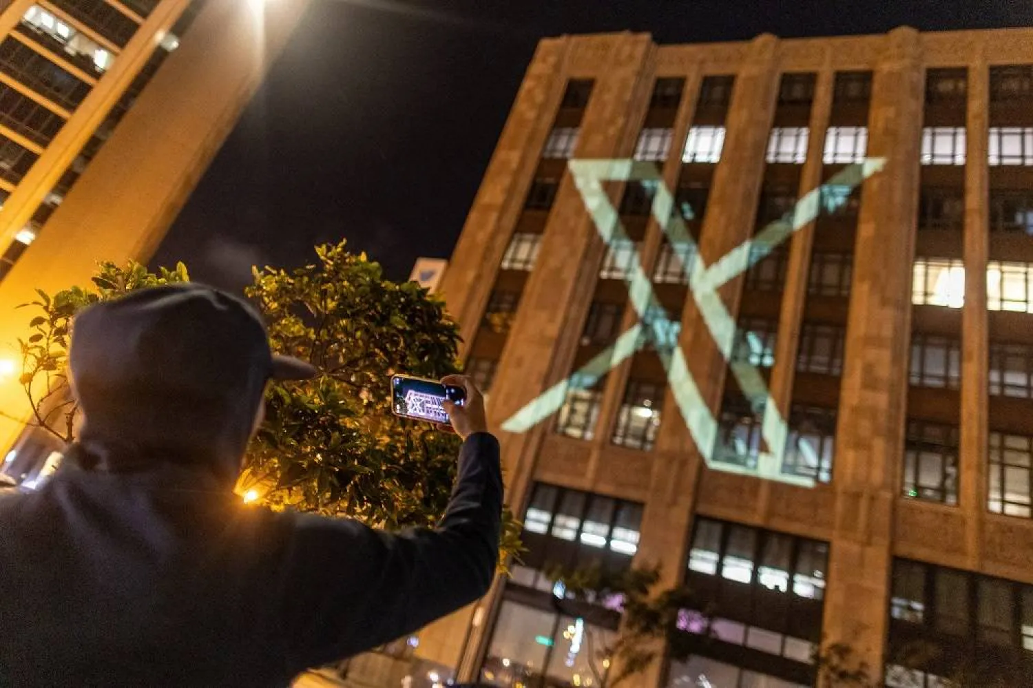 Twitter's new logo is seen projected on the corporate headquarters building in downtown San Francisco, California, US July 23, 2023. (Reuters)