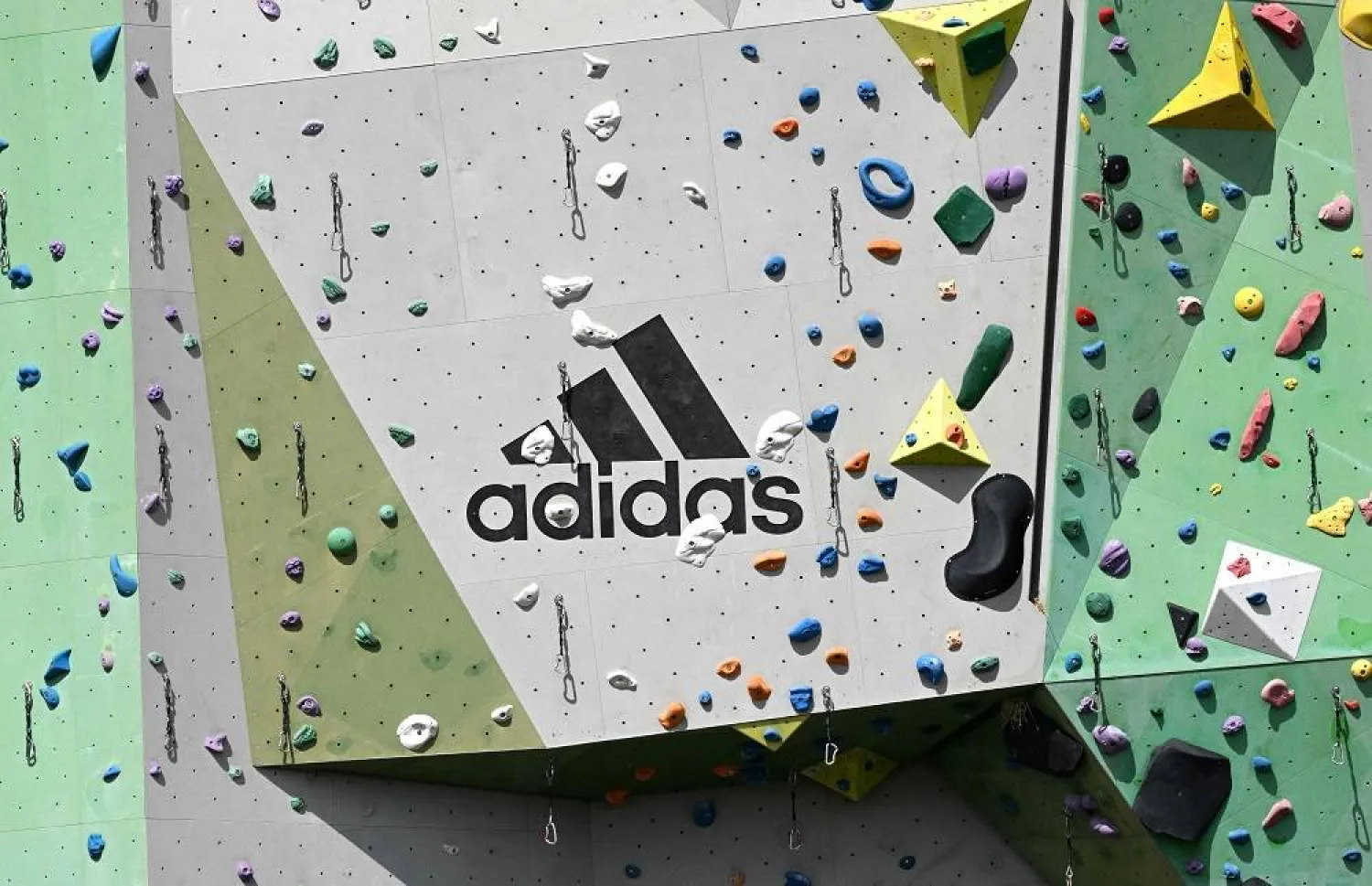 The company logo of Germany's sports equipment maker Adidas is seen at a climbing tower at the Adidas area in Herzogenaurach, southern Germany, on July 3, 2023. (AFP)