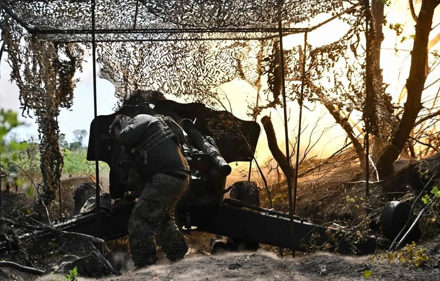 A Ukrainian artilleryman fires a 152 mm towed gun-howitzer D-20 at Russian positions on the front line near Bakhmut, eastern Ukraine, on July 20, 2023, amid the Russian invasion of Ukraine. (AFP)