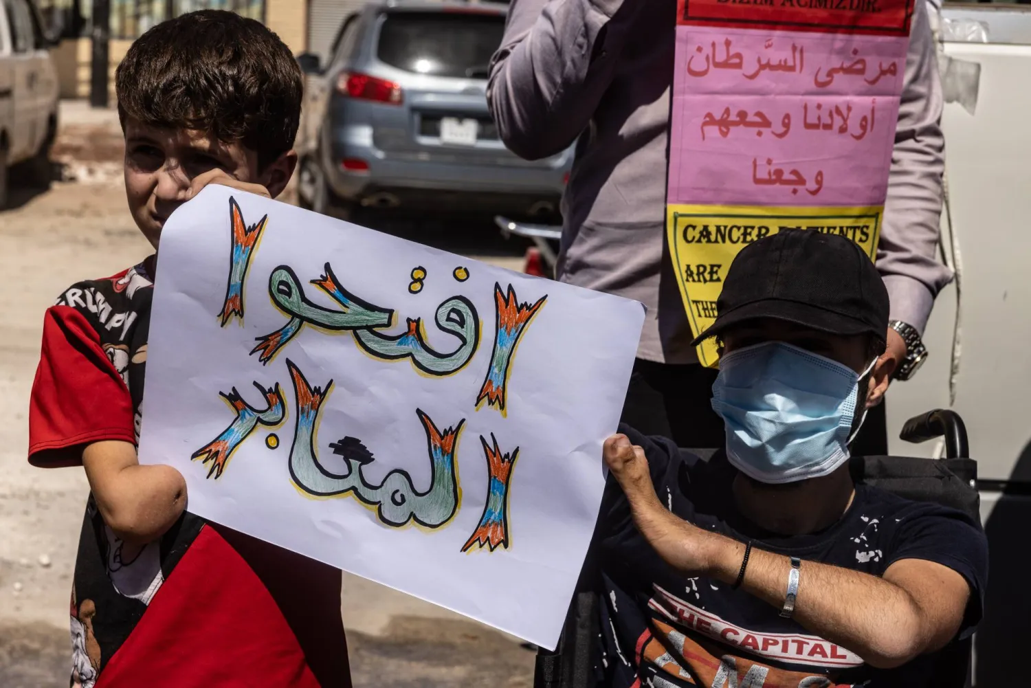 جانب من احتجاج للمطالبة بفتح الحدود التركية مع سوريا عند معبر باب الهوى بمحافظة إدلب يوم 22 يوليو الحالي (د.ب.أ)