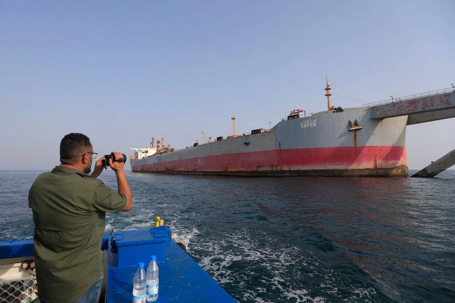 A man snaps a picture of the FSO Safer oil tanker in the Red Sea off the coast of Yemen's Hodeidah on July 15, 2023. AFP