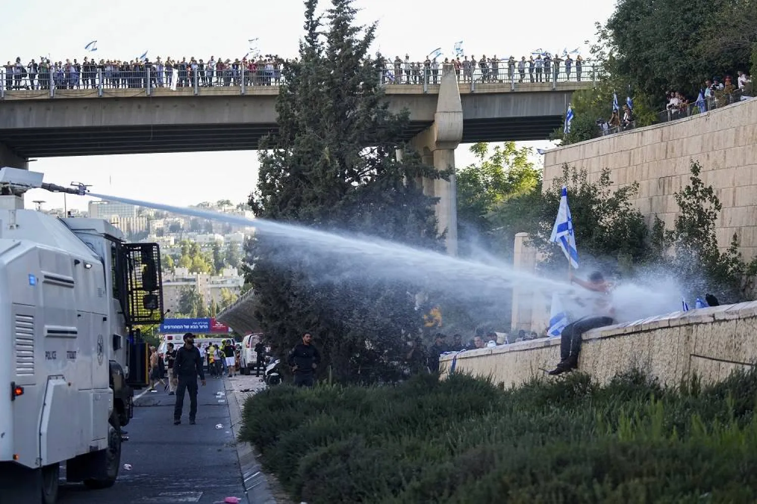 Israeli police use a water cannon to disperse demonstrators blocking a road during a protest against plans by Prime Minister Benjamin Netanyahu's government to overhaul the judicial system, in Jerusalem, Monday, July 24, 2023. (AP) 