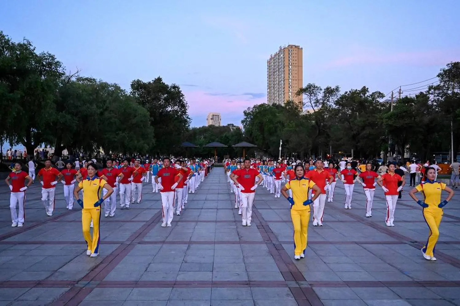 The photo taken on July 3, 2023 shows local residents taking part in an aerobics exercise called "Jiamusi Happy Dancing" at a square in Jiamusi, in northeastern China’s Heilongjiang province. (AFP) 