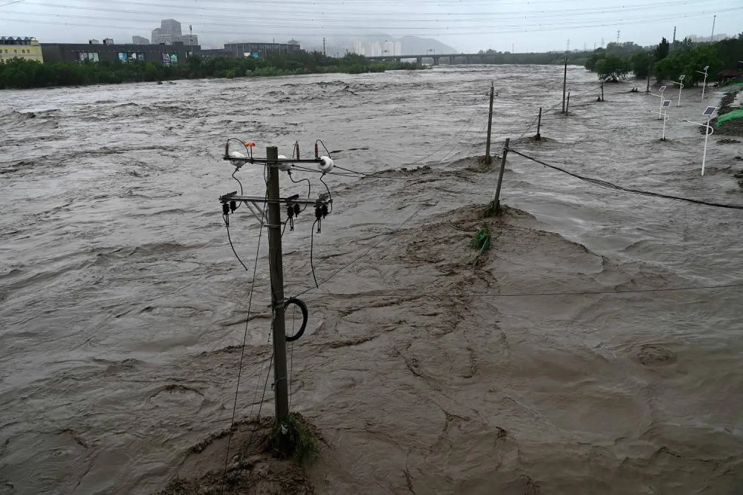 This picture shows a view of the overflooded Yongding river, after heavy rains in Mentougou district in Beijing on July 31, 2023. (AFP)