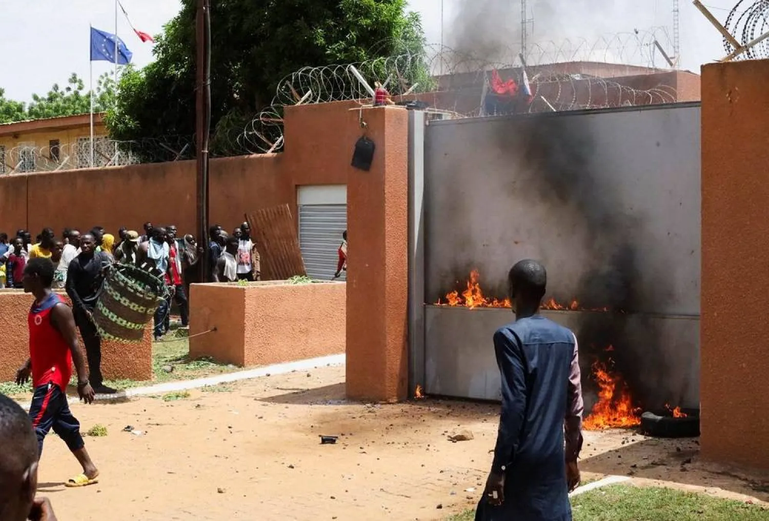 Pro-junta demonstrators gathered outside the French embassy, try to set it on fire before being dispersed by Nigerian security forces in Niamey, the capital city of Niger July 30, 2023. (Reuters)