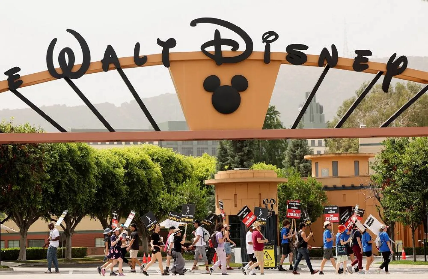  SAG-AFTRA actors and Writers Guild of America (WGA) writers walk the picket line during their ongoing strike outside Walt Disney Studios in Burbank, California, US, July 31, 2023. (Reuters)