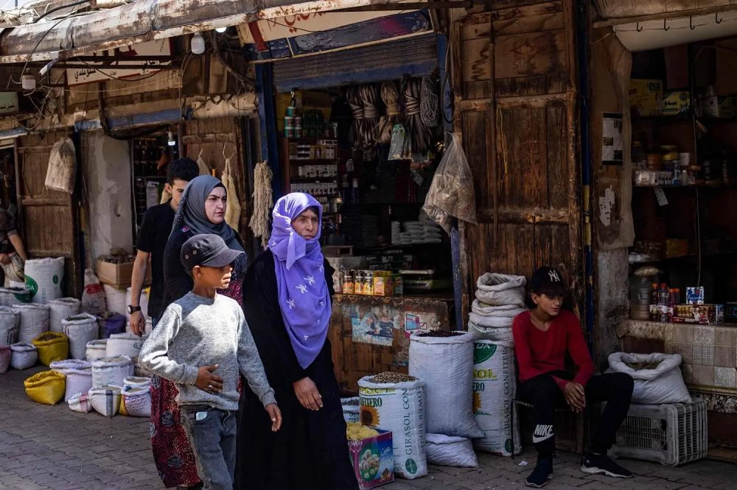  People shop at the Azra Alyahoodi (Azra the Jew) market also known as the "Jewish market", in the city of Qamishli in northeastern Syria, on July 27, 2023. (AFP)