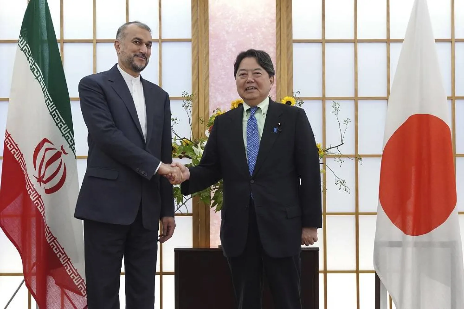 Japanese Foreign Minister Yoshimasa Hayashi, right, and Iranian counterpart Hossein Amir-Abdollahian shake hands before their meeting Monday, Aug. 7, 2023, in Tokyo. (AP)