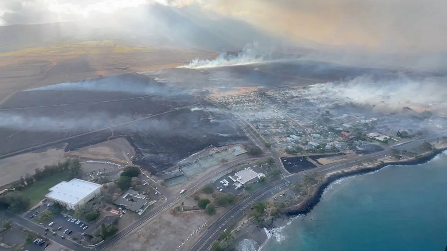 An aerial view as smoke rises from burnt areas amidst wildfires in Maui, Hawaii, US, August 9, 2023, in this screenshot taken from a social media video. (Vince Carter/via Reuters) 