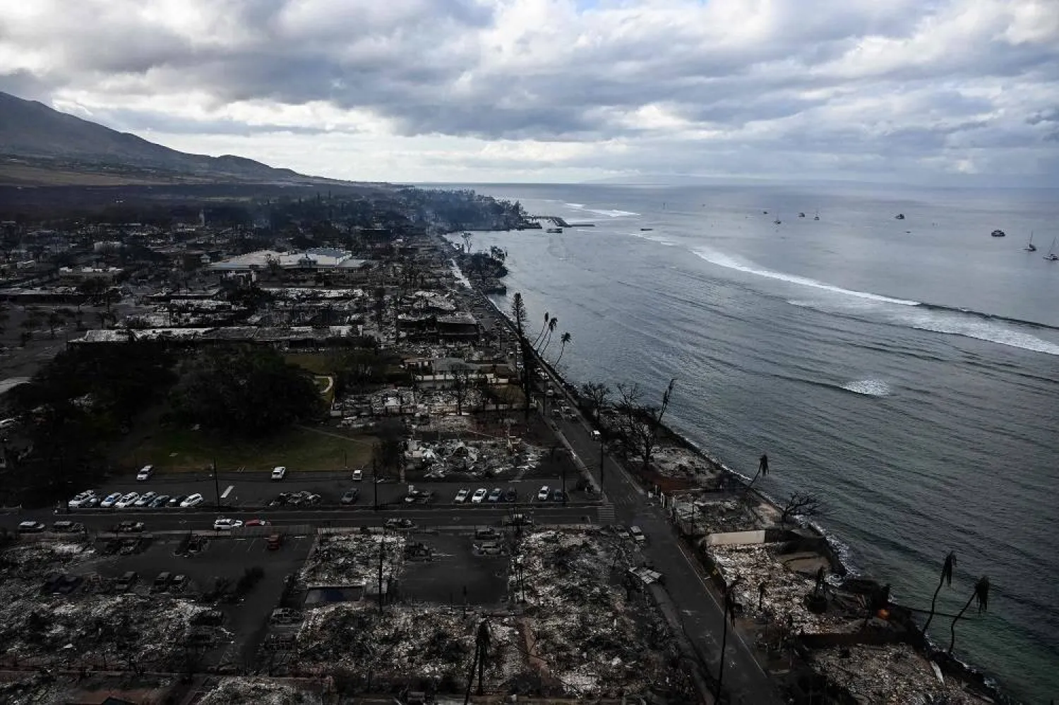 An aerial image taken on August 10, 2023 shows destroyed homes and buildings burned to the ground in Lahaina along the Pacific Ocean in the aftermath of wildfires in western Maui, Hawaii. (AFP)