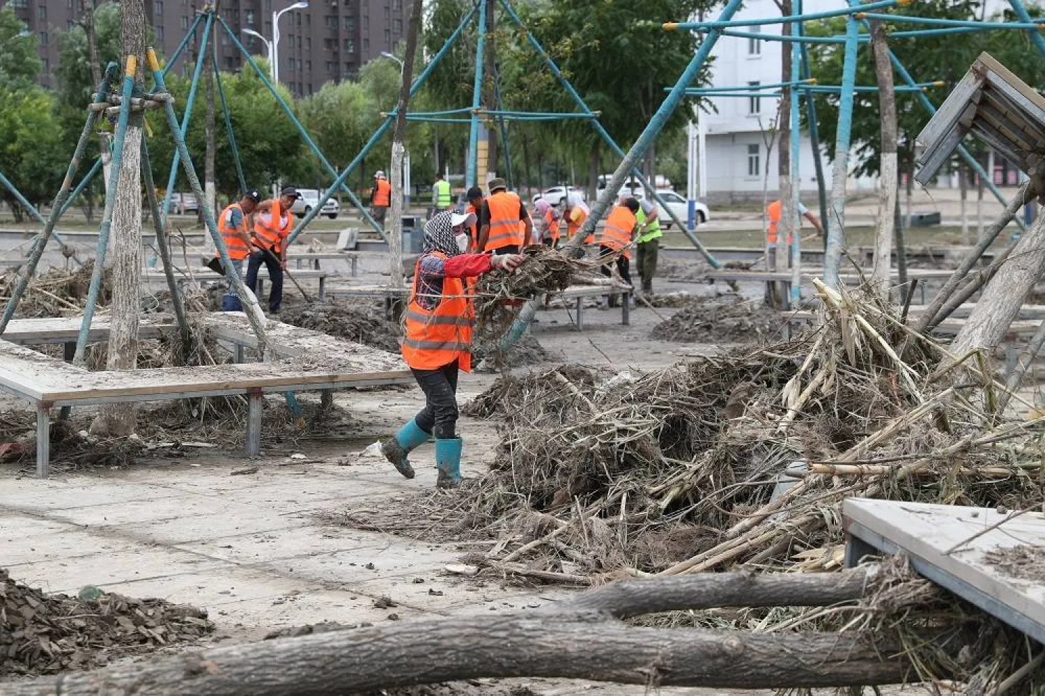 Sanitation workers clear a road lashed by floods in Shangzhi City, northeast China's Heilongjiang Province, 11 August 2023. (EPA/ Xinhua) 