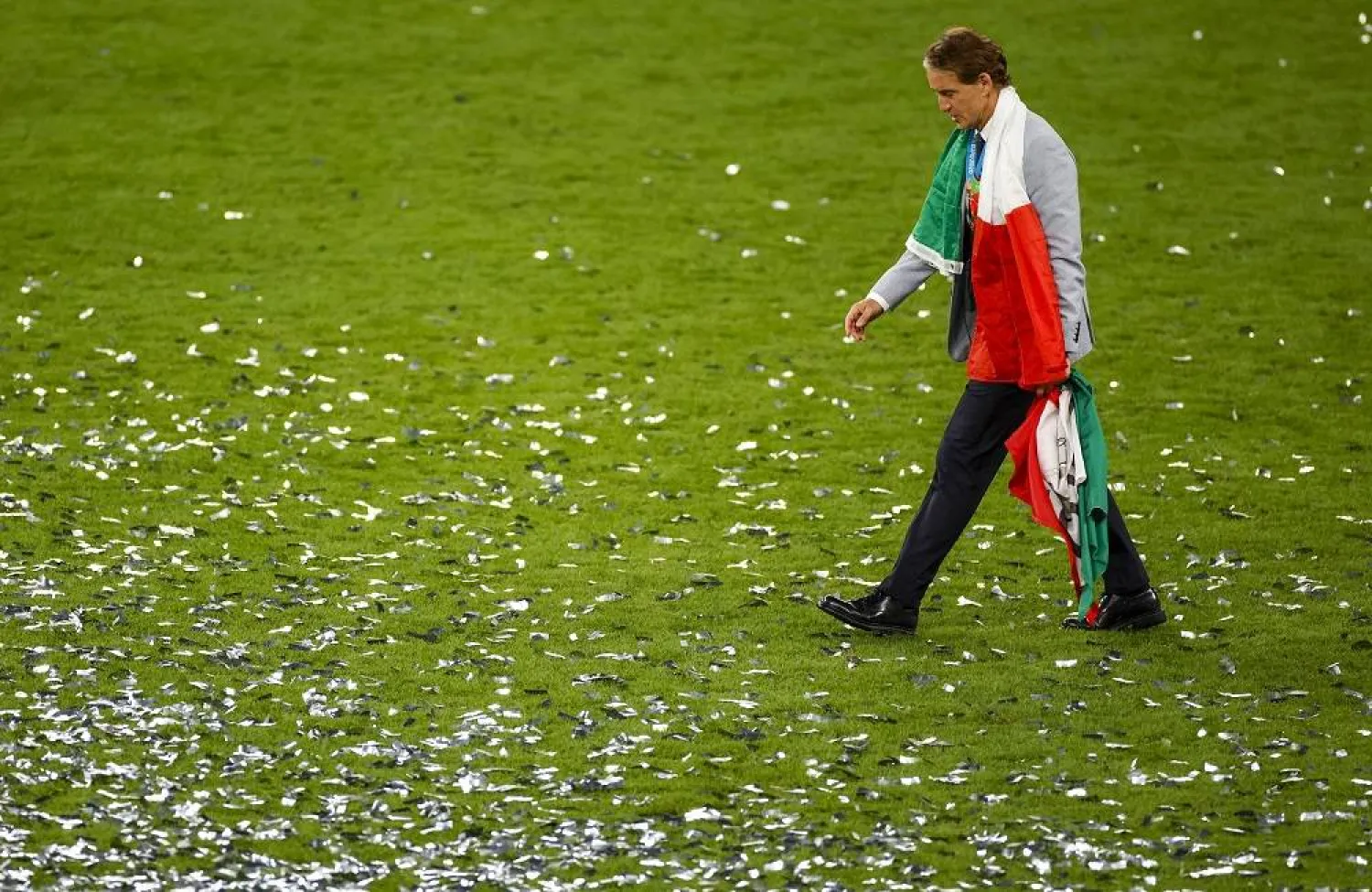  Italy's manager Roberto Mancini walks on the pitch after defeating England at the Euro 2020 soccer championship final at Wembley stadium in London, Sunday, July 11, 2021. (AP)