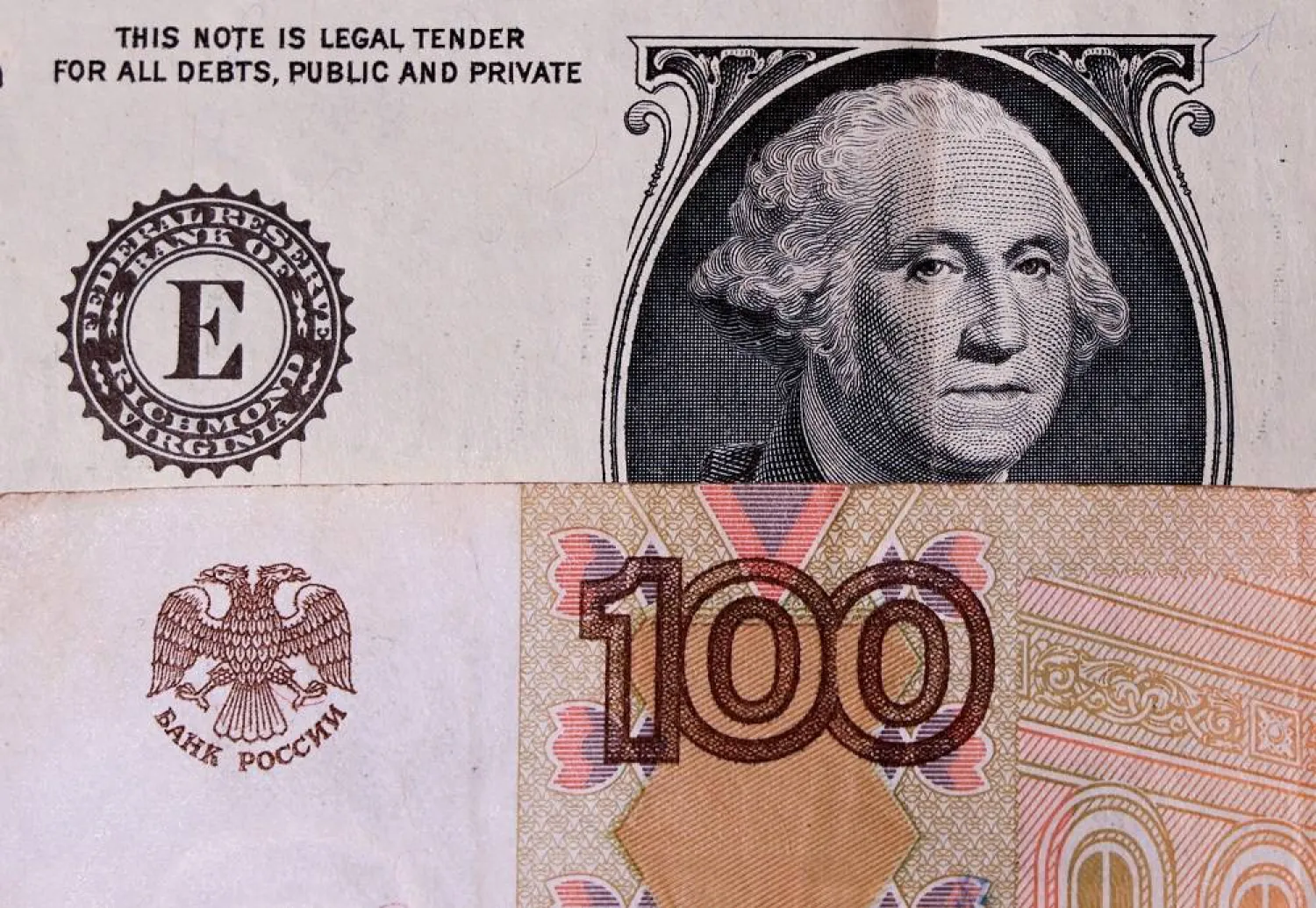 A view shows US one-dollar and Russian 100-rouble banknotes in this illustration picture taken August 14, 2023. (Reuters) 