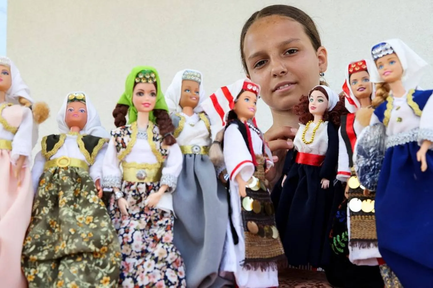 Esma Gljiva, an 11-year-old Bosnian girl, shows dolls that she dresses in traditional Bosnian costumes, hoping that her folklore Barbie will reach many, as the frenzy surrounding the launch of the "Barbie" movie spreads across the world, in Sarajevo, Bosnia and Herzegovina, August 15, 2023. (Reuters) 