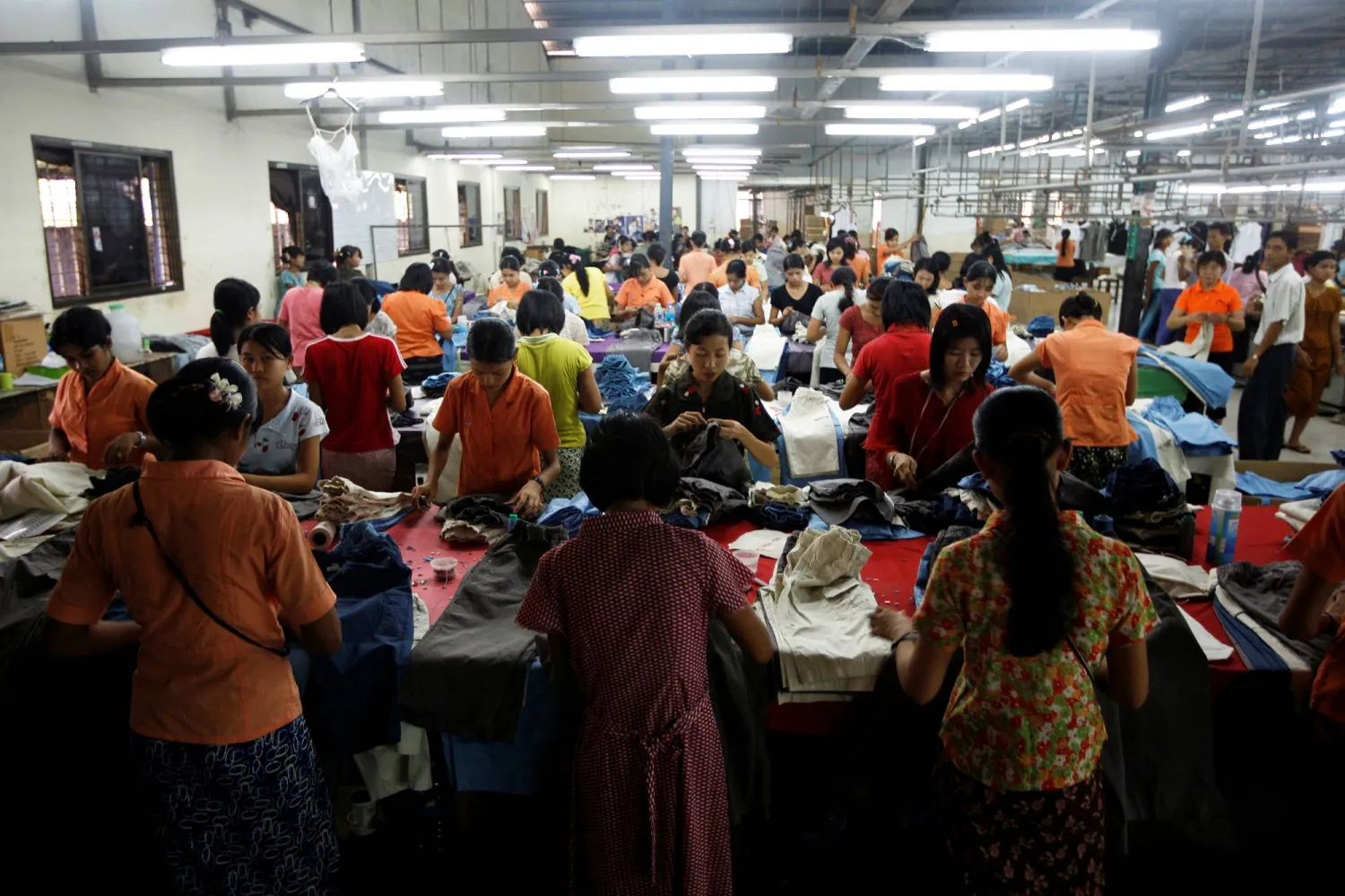 FILE PHOTO: Workers tailor and arrange clothing at a garment factory at Hlaing Tar Yar industry zone in Yangon March 10, 2010. REUTERS/Soe Zeya Tun/File Photo