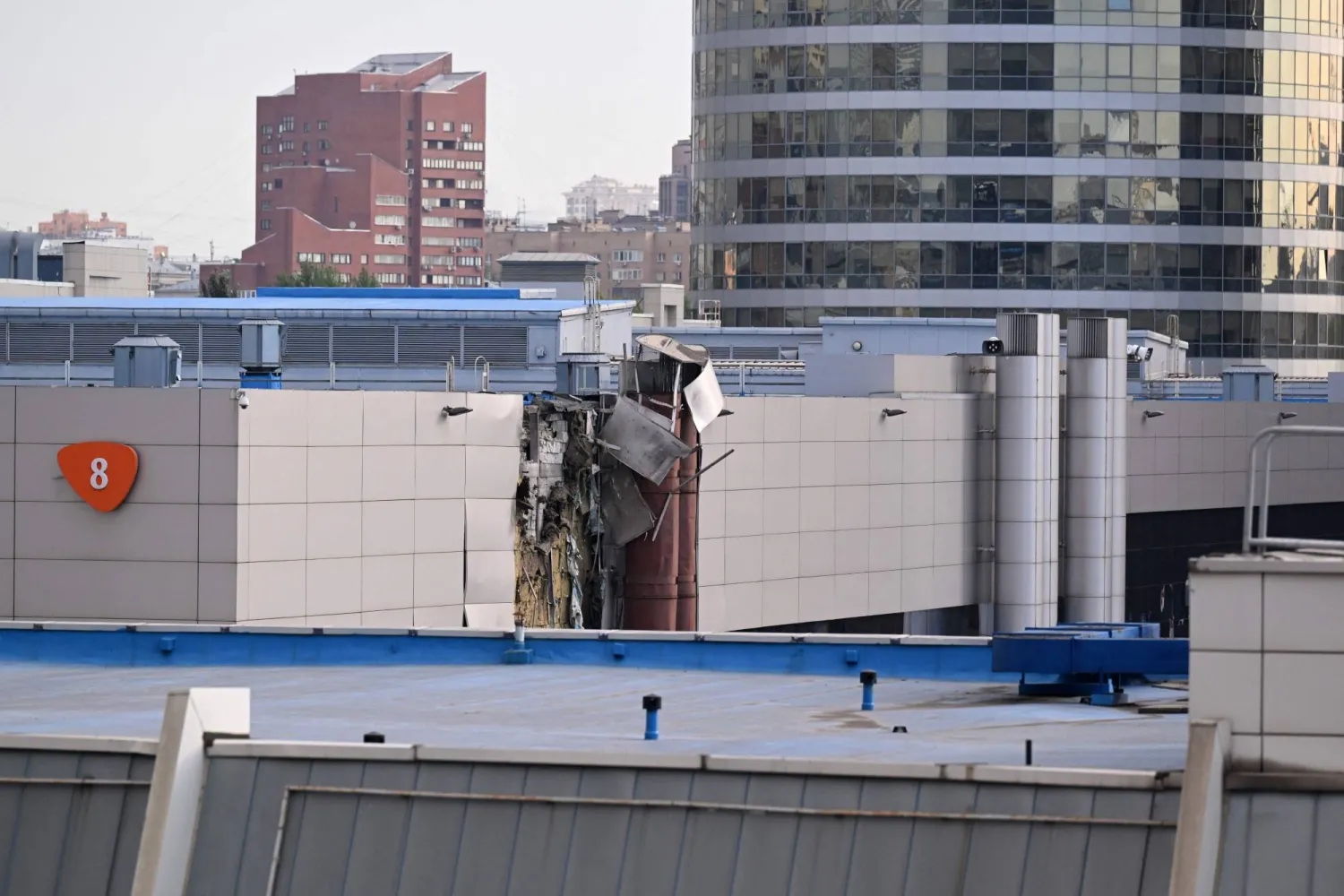 This photo shows damage on an Expo Center building following a drone attack in Moscow on August 18, 2023. (Photo by NATALIA KOLESNIKOVA / AFP)