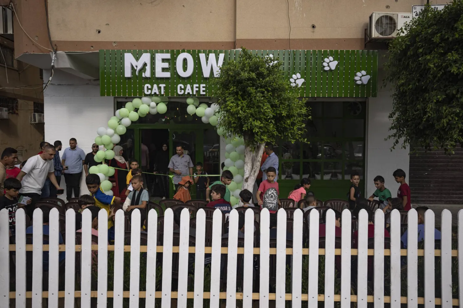 Palestinians gather for the opening ceremony of Meow Cafe in Gaza City, Thursday, Aug 17, 2023. (AP Photo/Fatima Shbair)