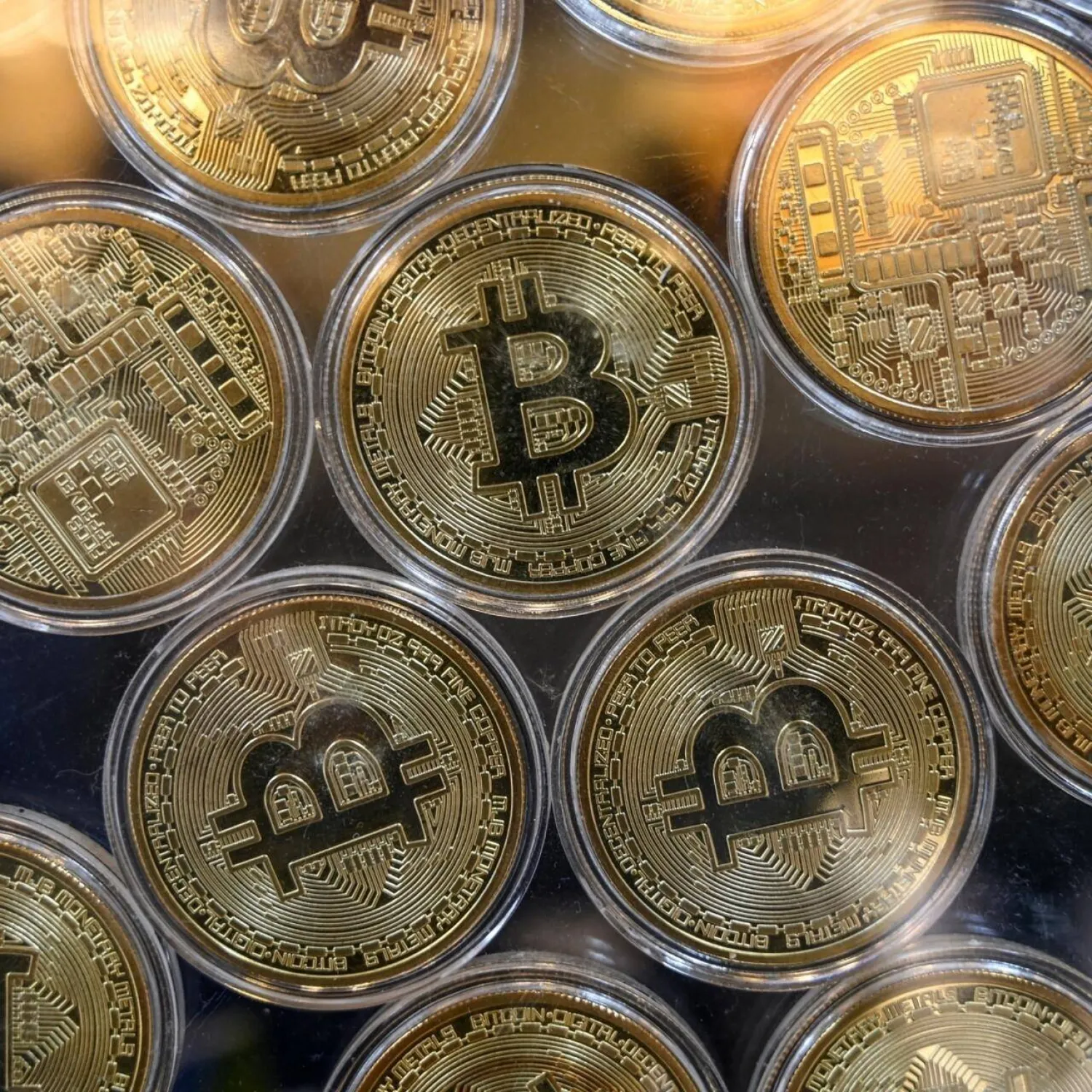 File photo: Physical imitation of Bitcoins are pictured at a cryptocurrency exchange branch near the Grand Bazaar in Istanbul on October 20, 2021, a day after Bitcoin took another step closer to mainstream investing with the launch of a new security on Wall Street tied to futures of the cryptocurrency. Ozan Koze, AFP archive