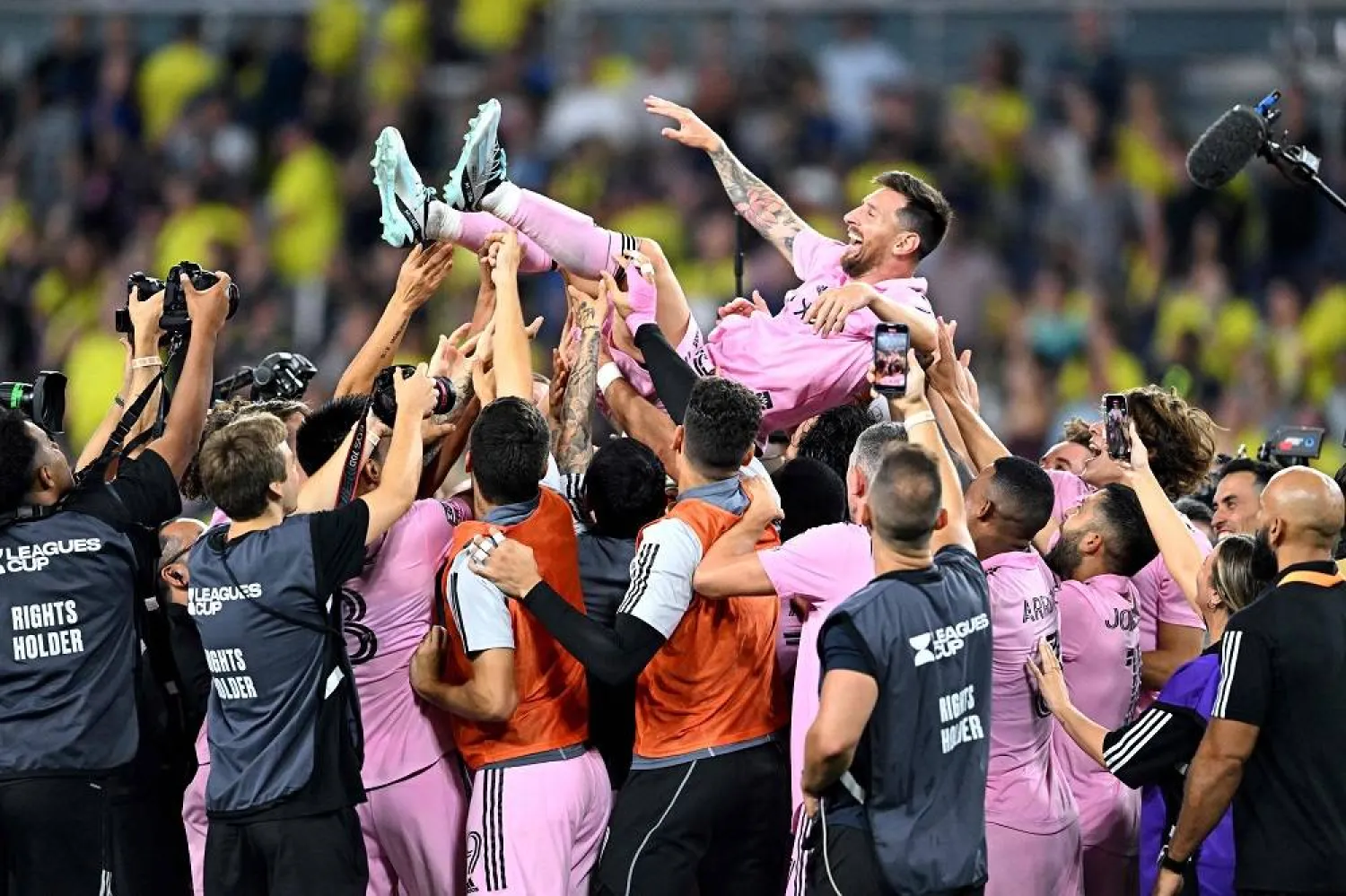 Teammates hold up Inter Miami's Argentine forward #10 Lionel Messi as they celebrate after winning the Leagues Cup final football match against Nashville SC at Geodis Park in Nashville, Tennessee, on August 19, 2023. (AFP)
