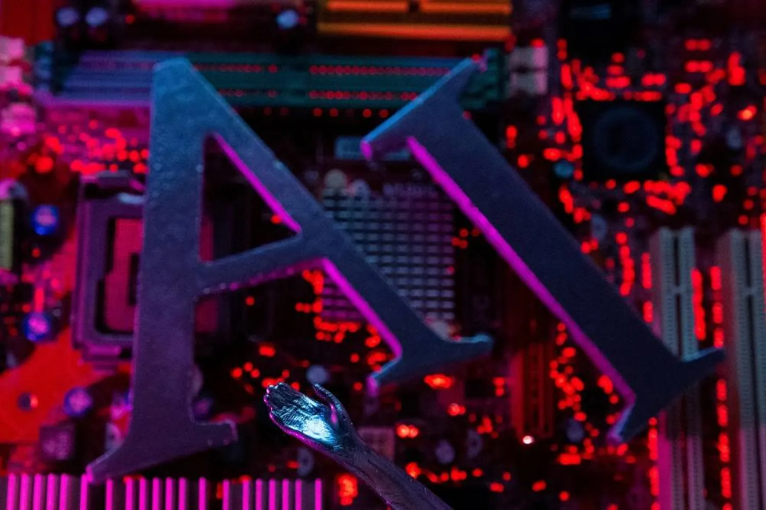 AI (Artificial Intelligence) letters and robot hand are placed on computer motherboard in this illustration taken, June 23, 2023. (Reuters)
