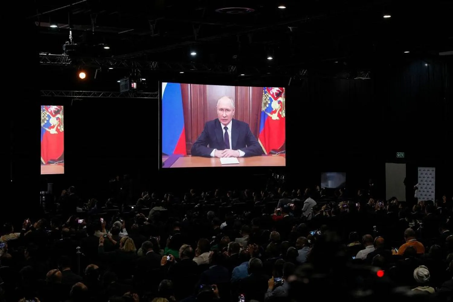  Russian President Vladimir Putin delivers his remarks virtually during the 2023 BRICS Summit at the Sandton Convention Center in Johannesburg on August 22, 2023. (AFP)