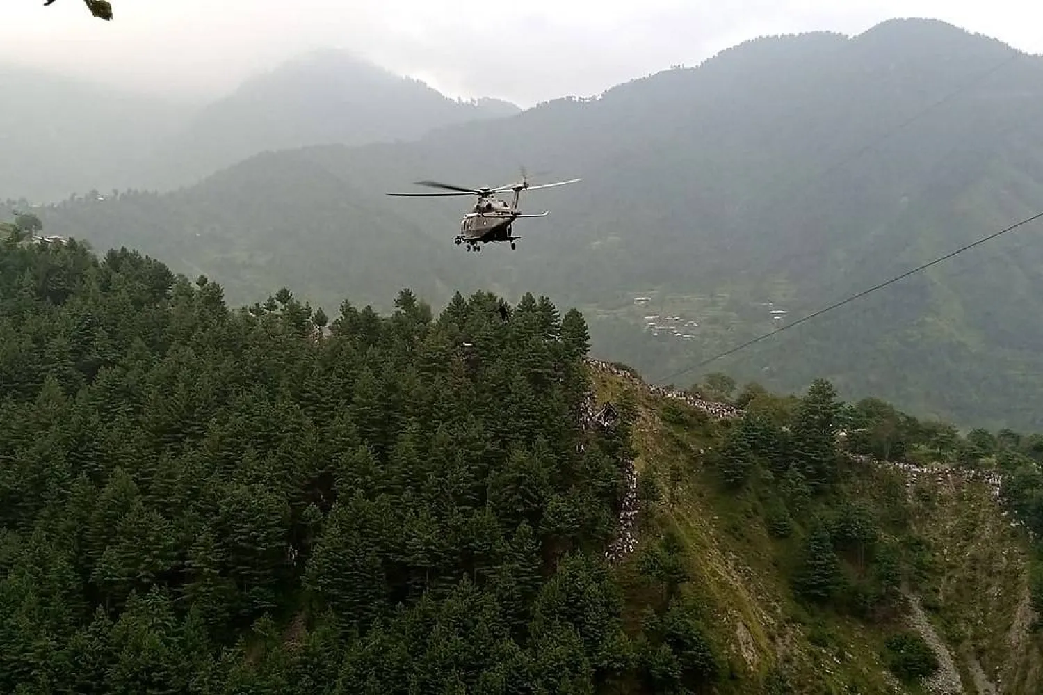A military helicopter conducts a rescue operation to recover students stuck in a chairlift in the Pashto village of mountainous Khyber Pakhtunkhwa province, on August 22, 2023. (AFP)