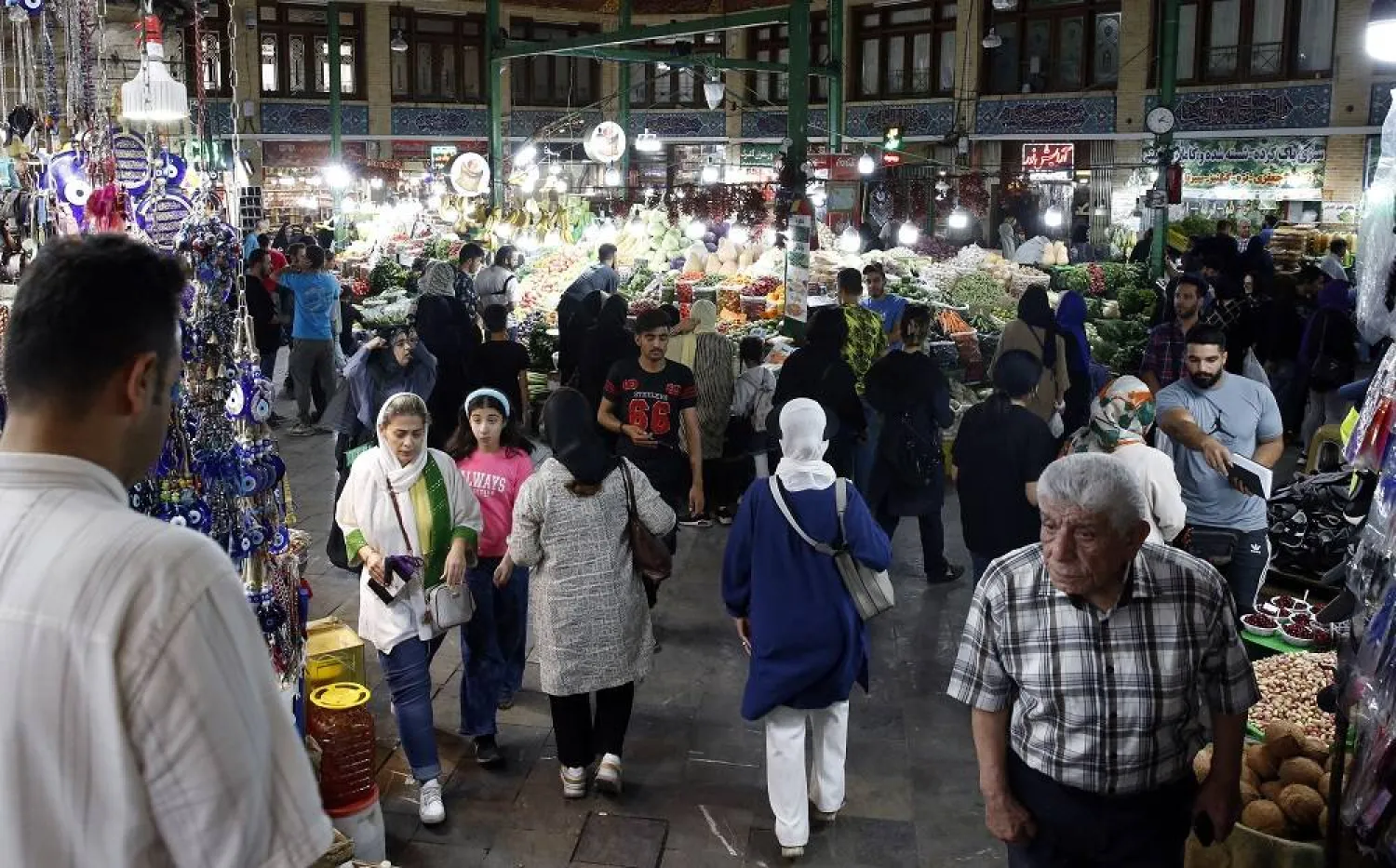 Iranians shop at the Tajrish bazaar in Tehran, Iran, 21 August 2023. (EPA)