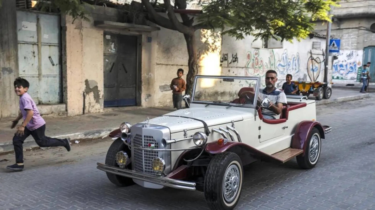 Munir al-Shandi drives his Gazelle down a Gaza street.  MOHAMMED ABED / AFP

