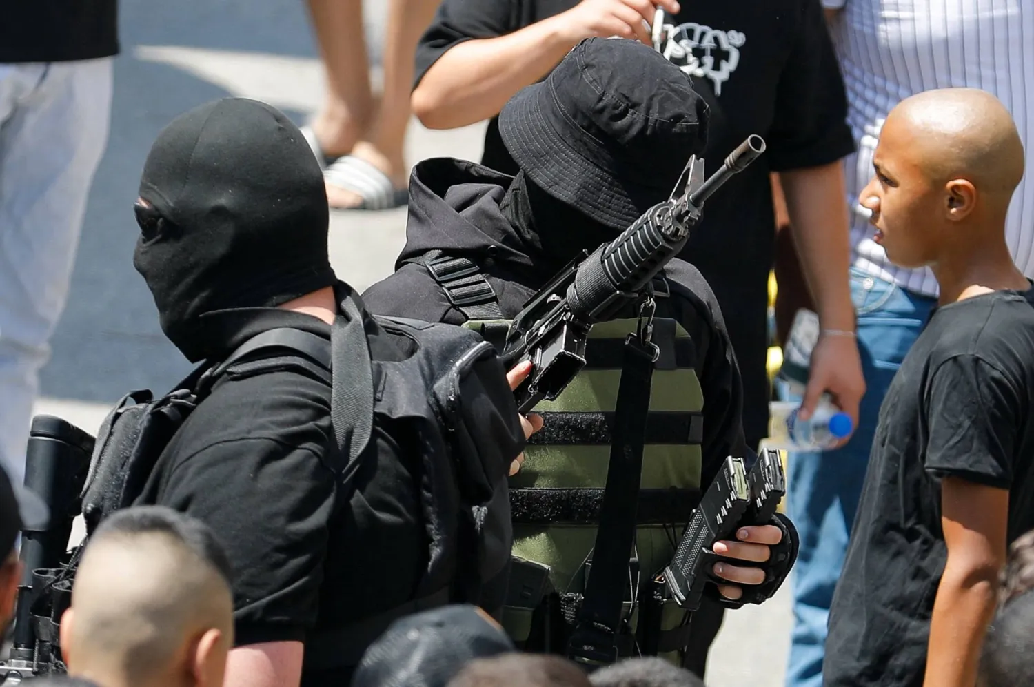 Armed men attend the funeral of a Palestinian who was killed in an Israeli raid, in Tulkarm, in the Israeli-occupied West Bank August 11, 2023. REUTERS/Raneen Sawafta