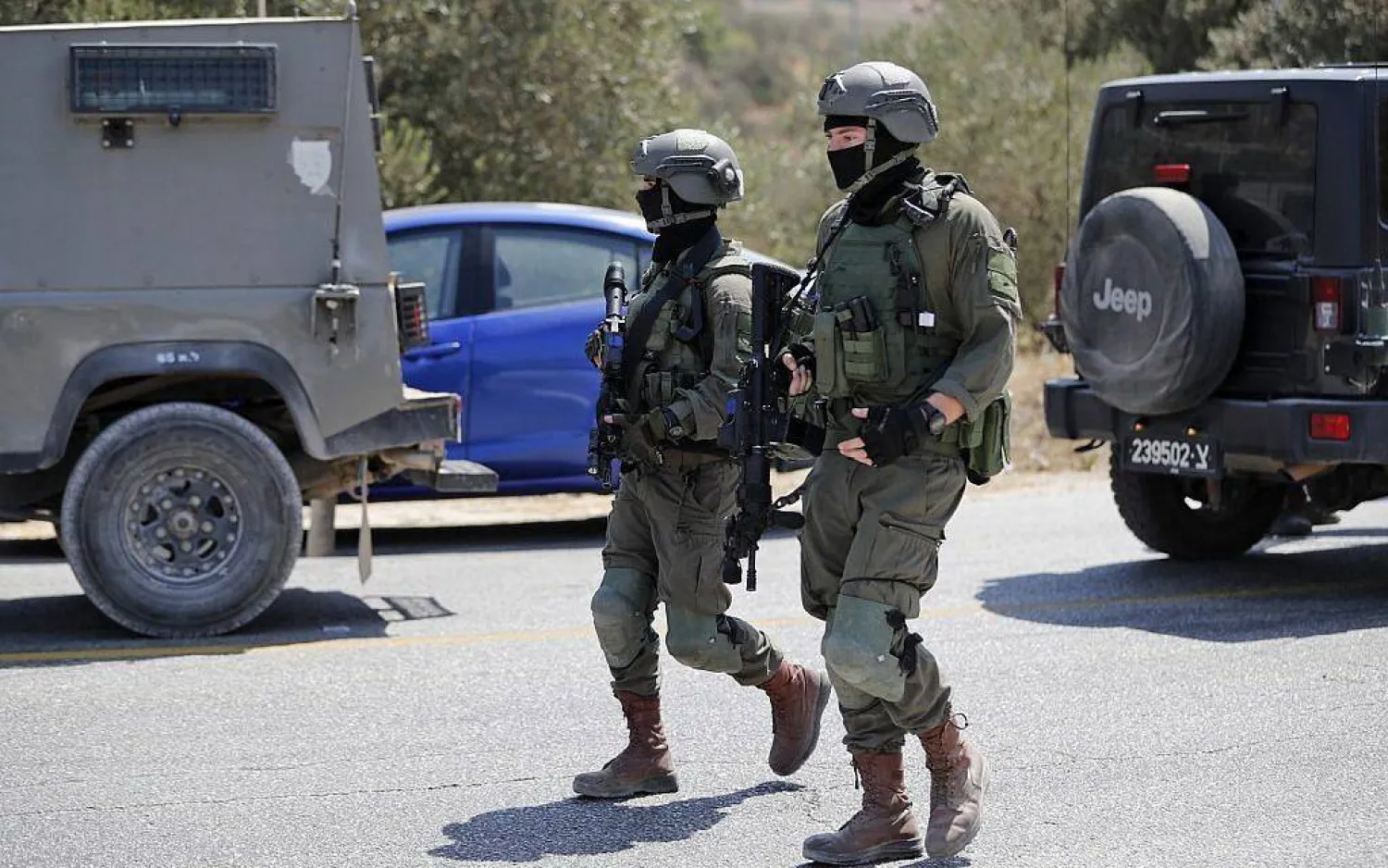 File photo: Israeli soldiers stand at the site where a bomb exploded near the Israeli settlement of Dolev in the West Bank on August 23, 2019, injuring three people (Ahmad GHARABLI / AFP)