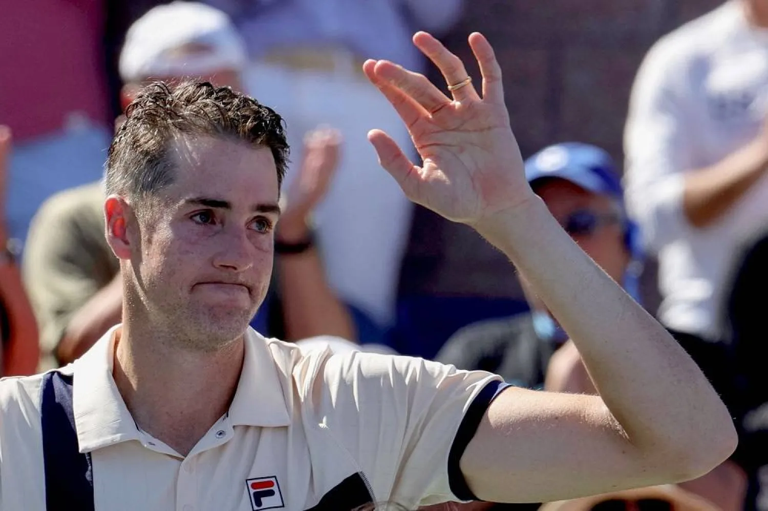 USA's John Isner waves after losing against USA's Michael Mmoh during the US Open tennis tournament men's singles second round match at the USTA Billie Jean King National Tennis Center in New York City, on August 31, 2023. (AFP)