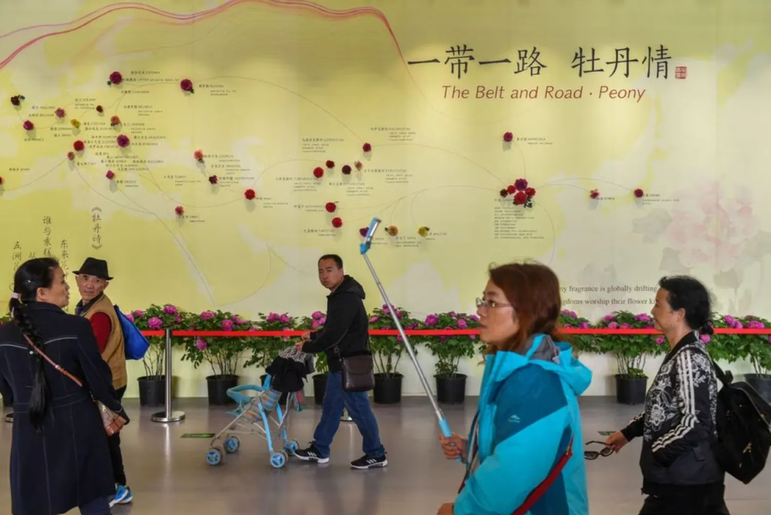 Visitors walk past a wall with a map showing the species of peony in Belt and Road Initiative (BRI) countries, at horticultural exhibition Beijing Expo 2019, in Beijing, China April 29, 2019. Picture taken April 29, 2019. REUTERS/Stringer/file photo Acquire Licensing Rights

